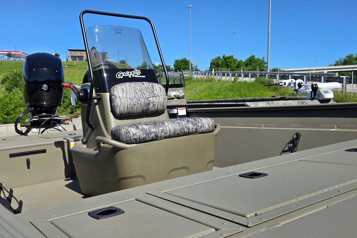2026 Tracker Grizzly 2072 CC boat with camouflage seating and powerful outboard motor.