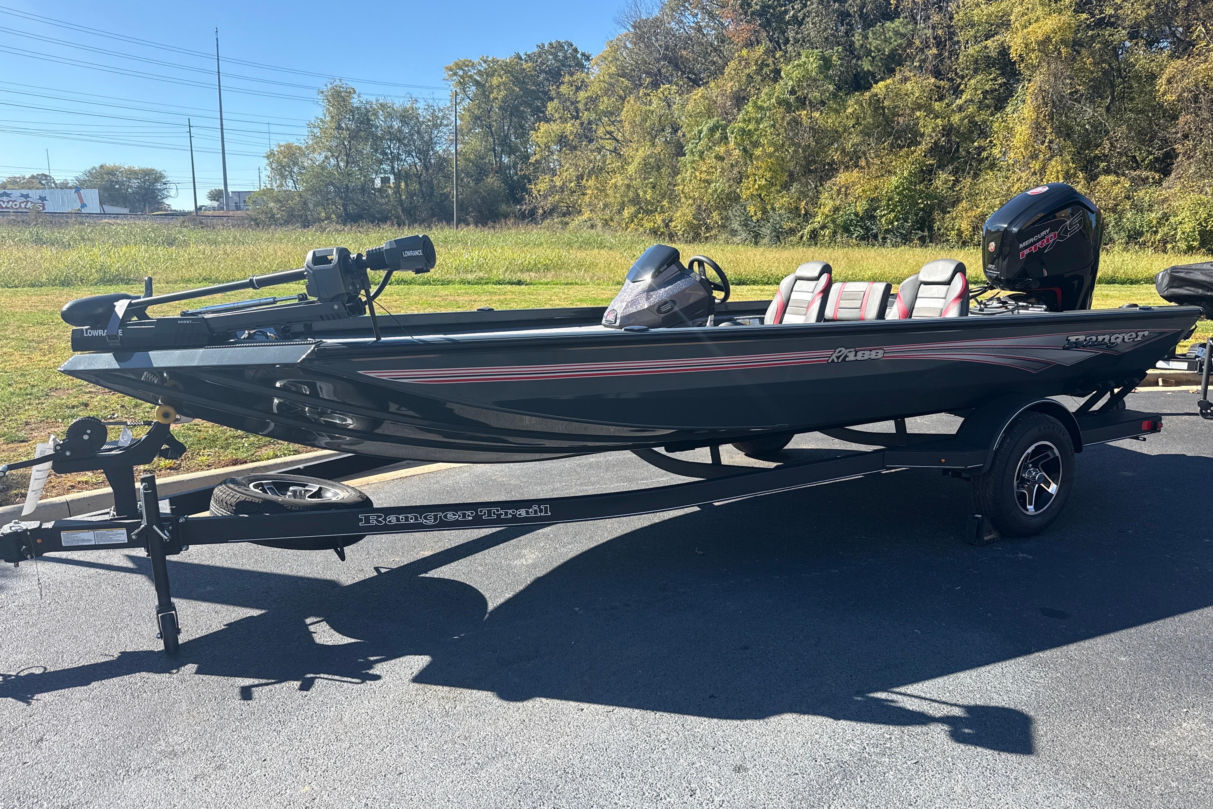 2025 Ranger RT188 boat on trailer, parked outdoors, with trees in the background.