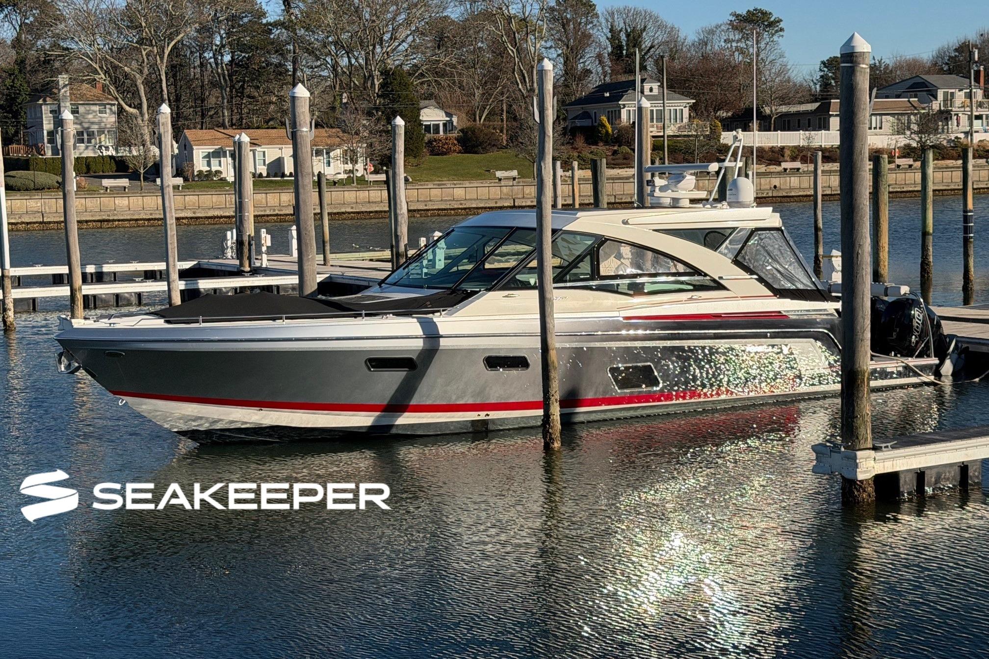 2017 Formula 430 Super Sport Crossover yacht docked at marina with Seakeeper logo.