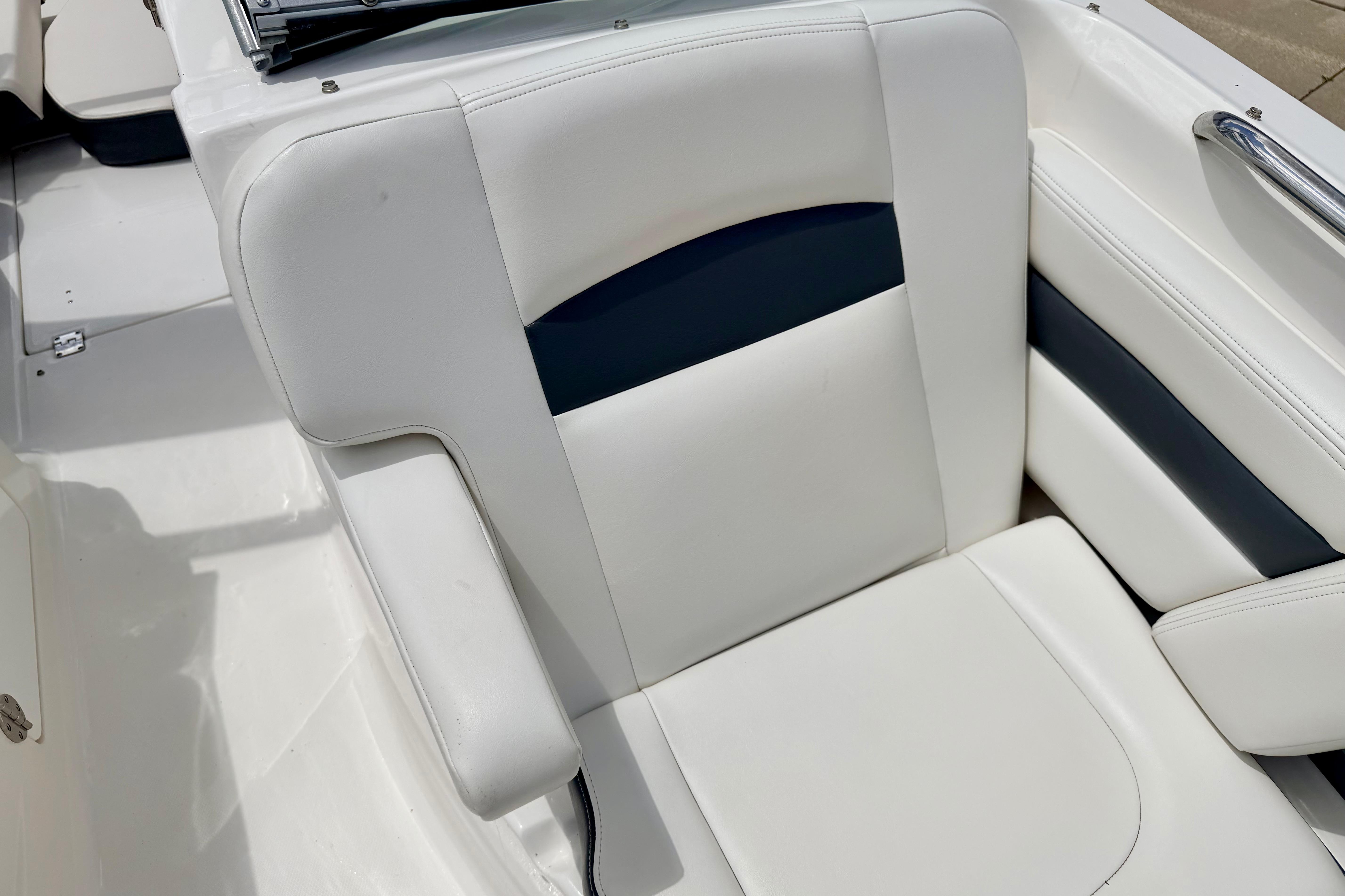 2015 Chaparral Sunesta 264 boat seat with white and navy upholstery.