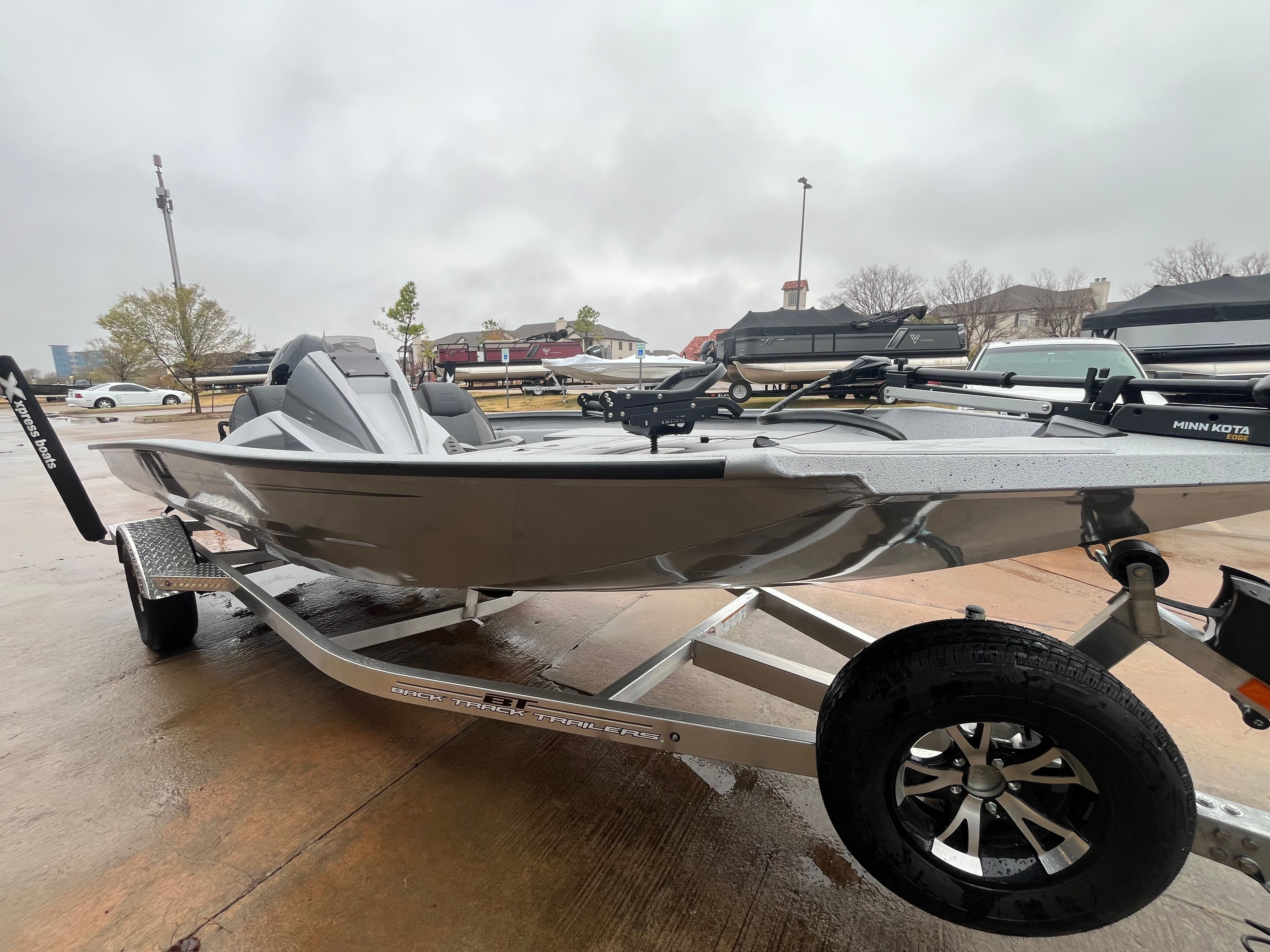2026 Xpress H18C Crappie boat on trailer in overcast weather.
