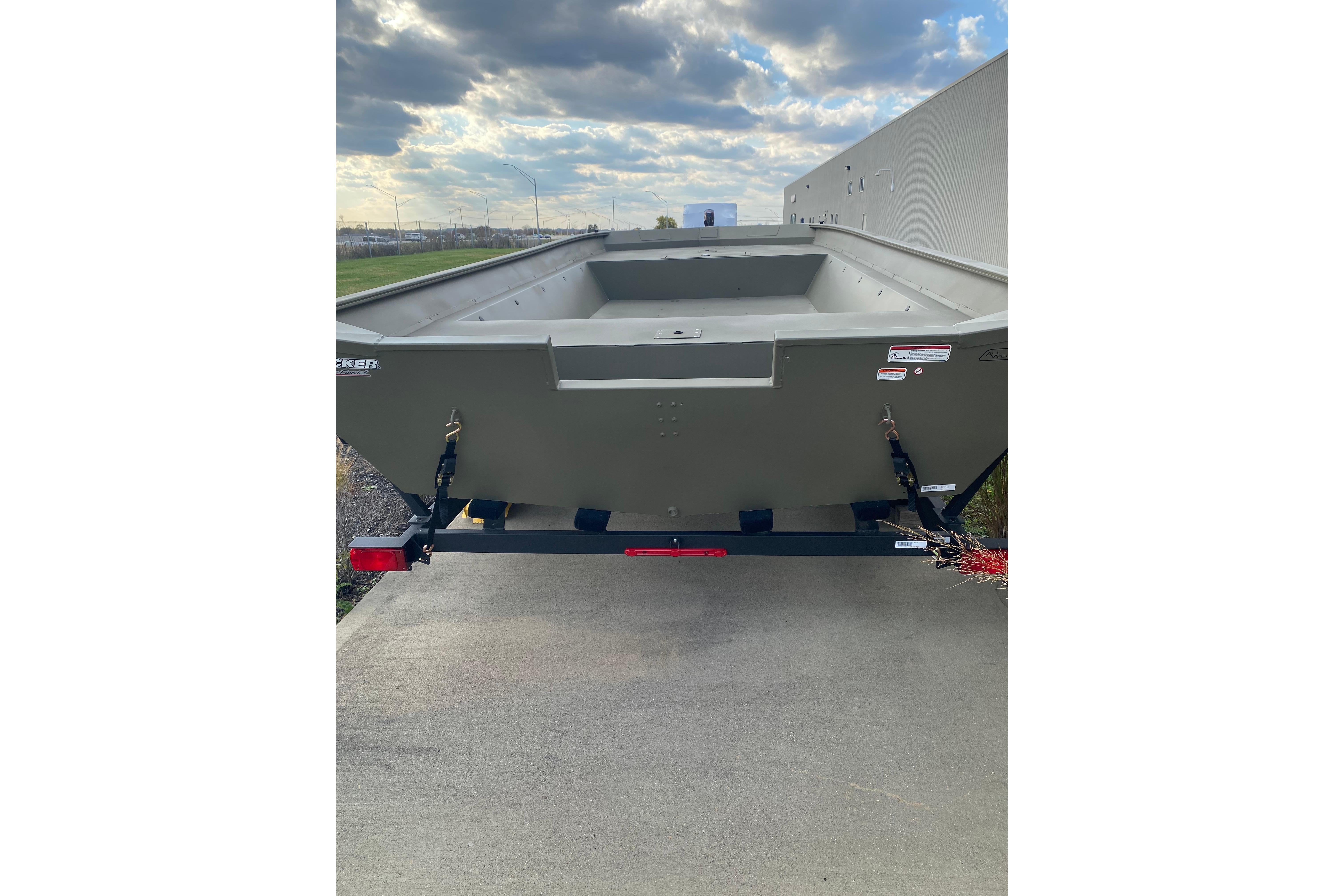 2026 Tracker Grizzly 2072 Utility boat on trailer, parked outdoors under cloudy sky.