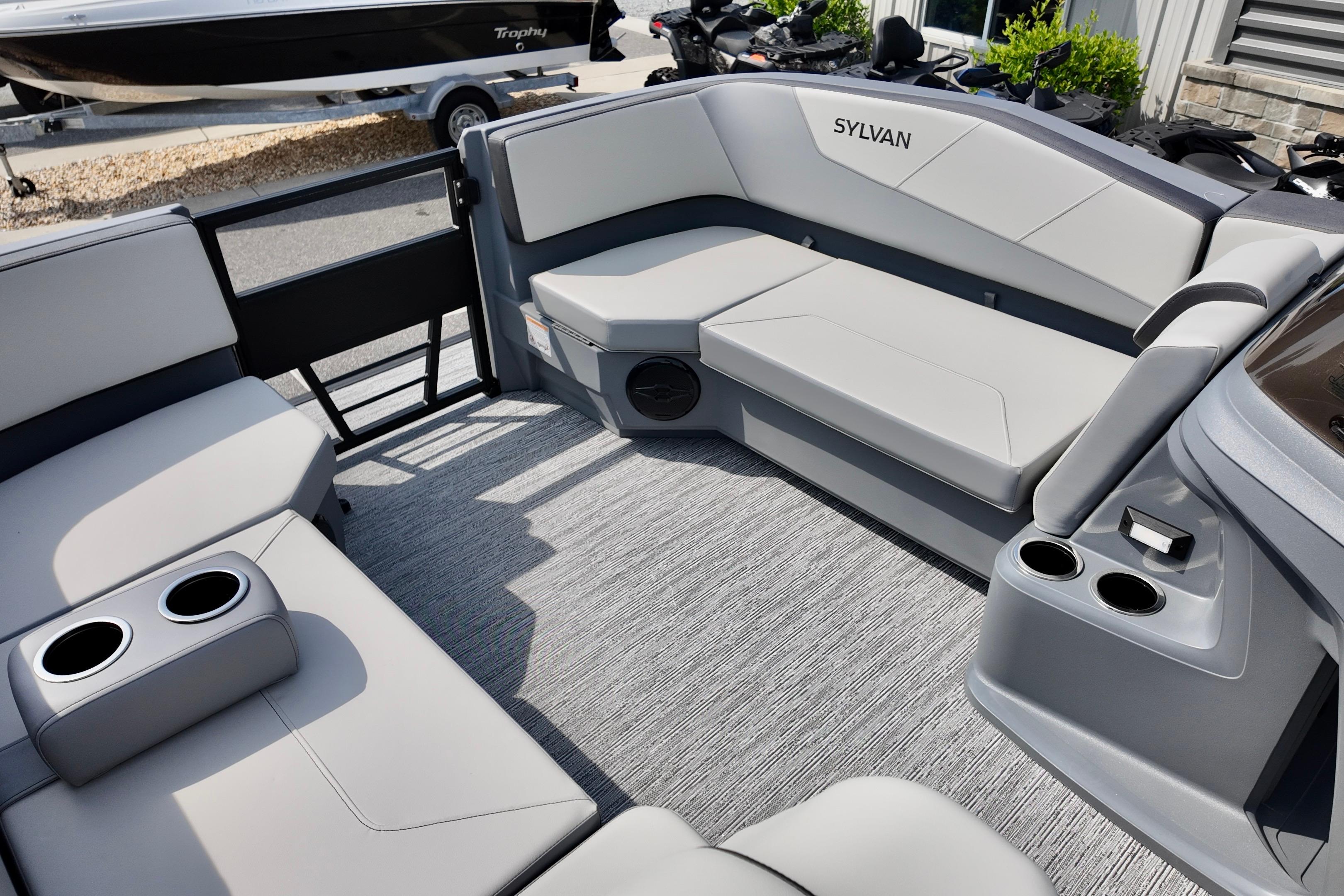 Luxurious interior of 2026 Sylvan A-20 LZ DH pontoon boat with plush seating and cup holders.