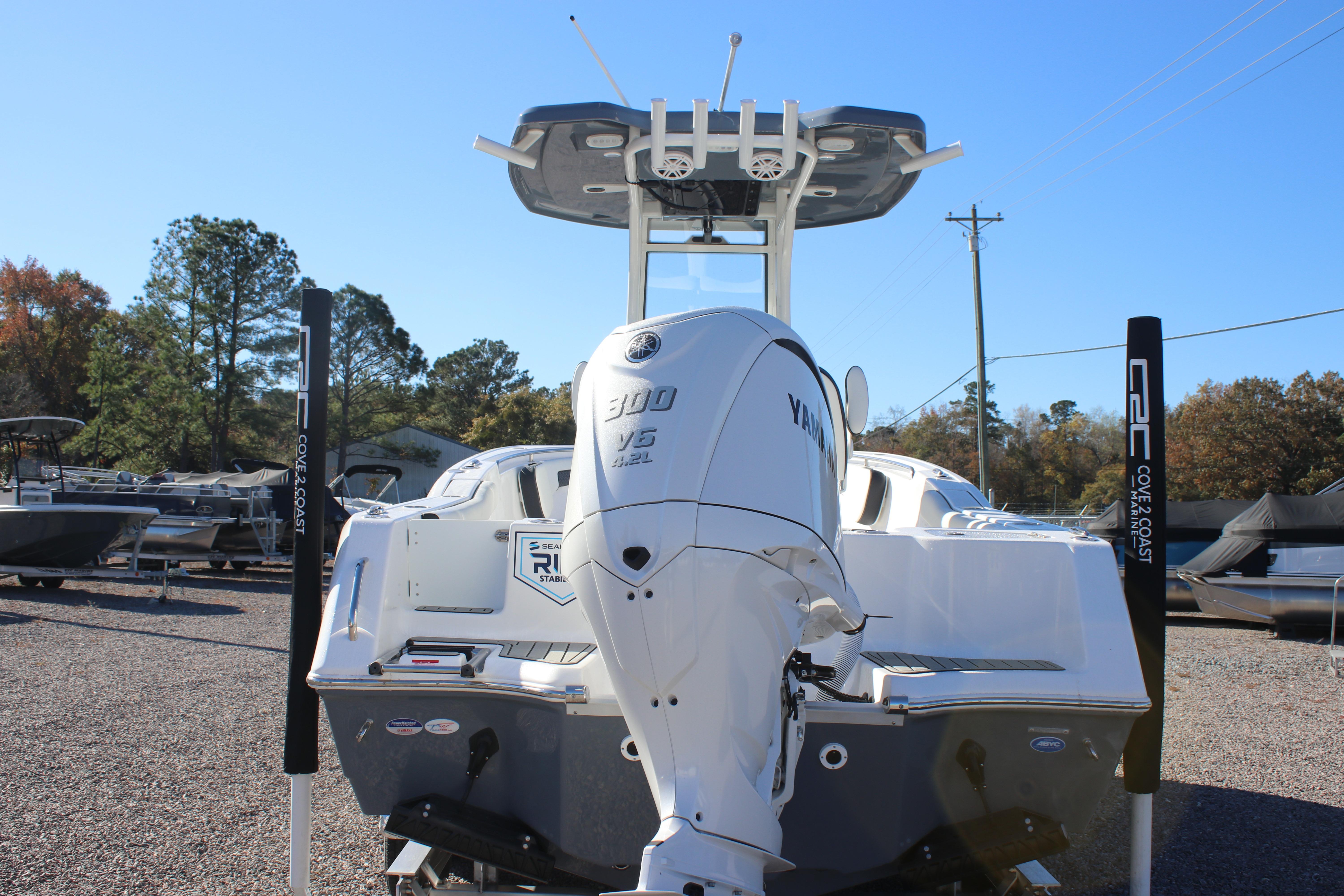 2026 Tidewater 232 CC Adventure boat with Yamaha 300 V6 engine, parked outdoors.