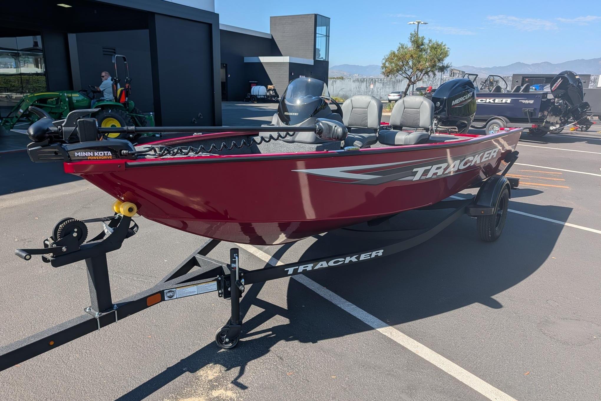 2026 Tracker Super Guide V-16 SC boat in parking lot, featuring Minn Kota motor.