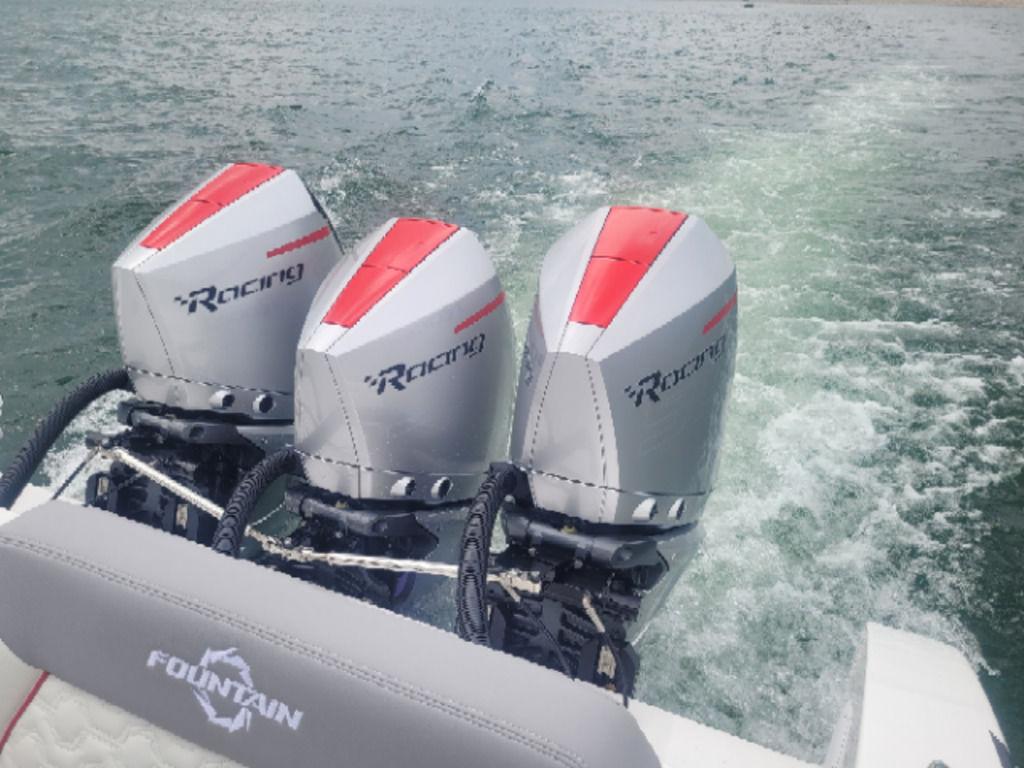 2024 Fountain 38 SCX boat with triple Racing outboard engines on water.