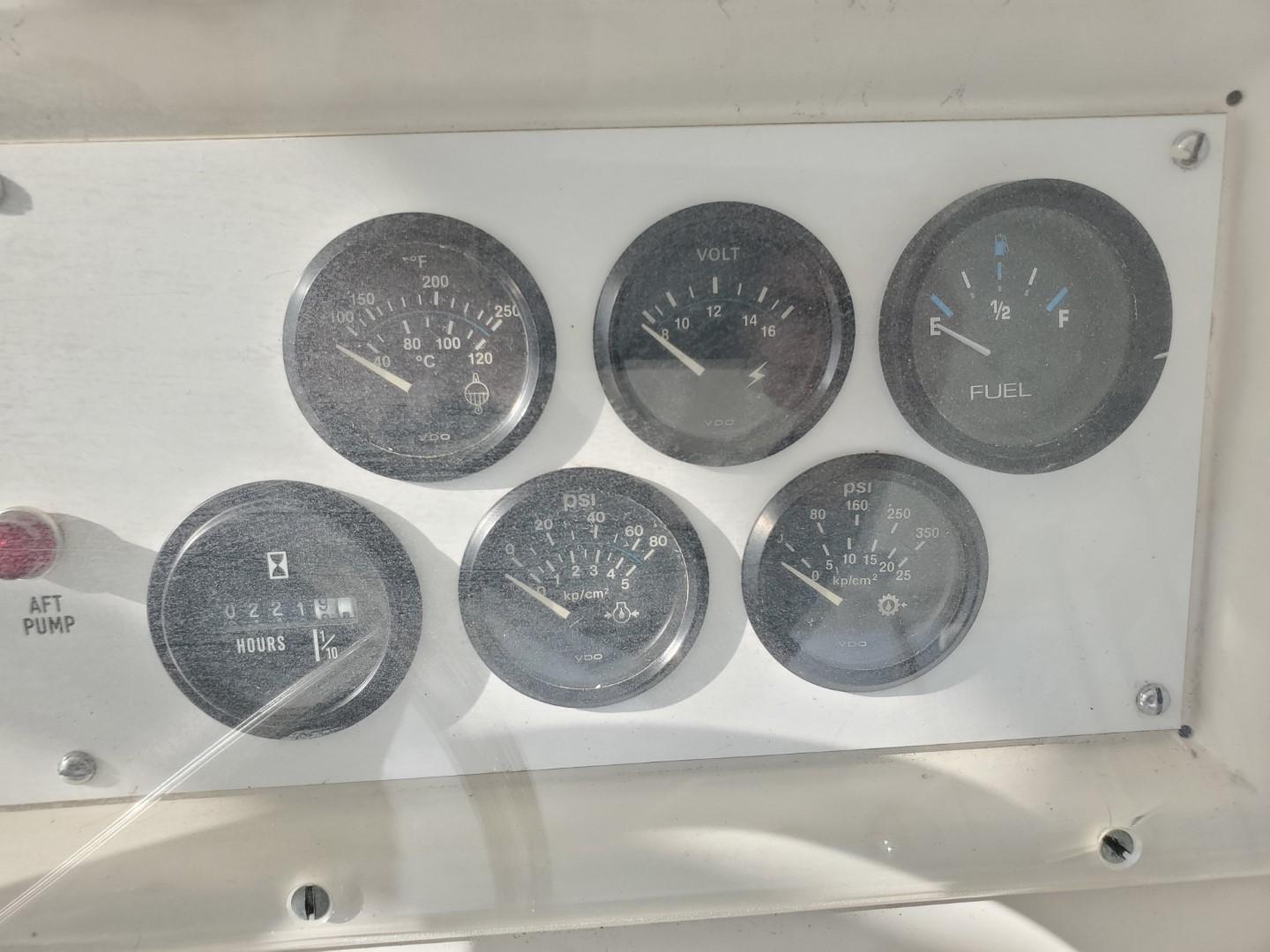 Dashboard gauges of a 1988 Post 46 Sportfish boat, showing various engine metrics.