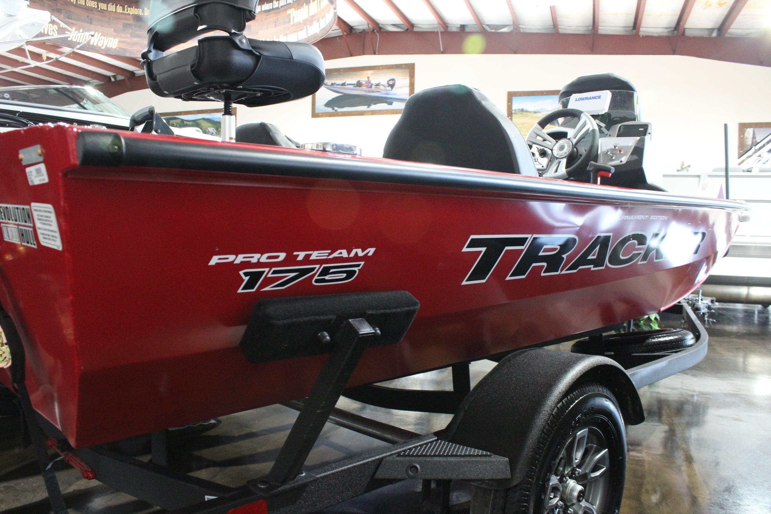 2026 Tracker Pro Team 175 boat in showroom, red exterior, side view.
