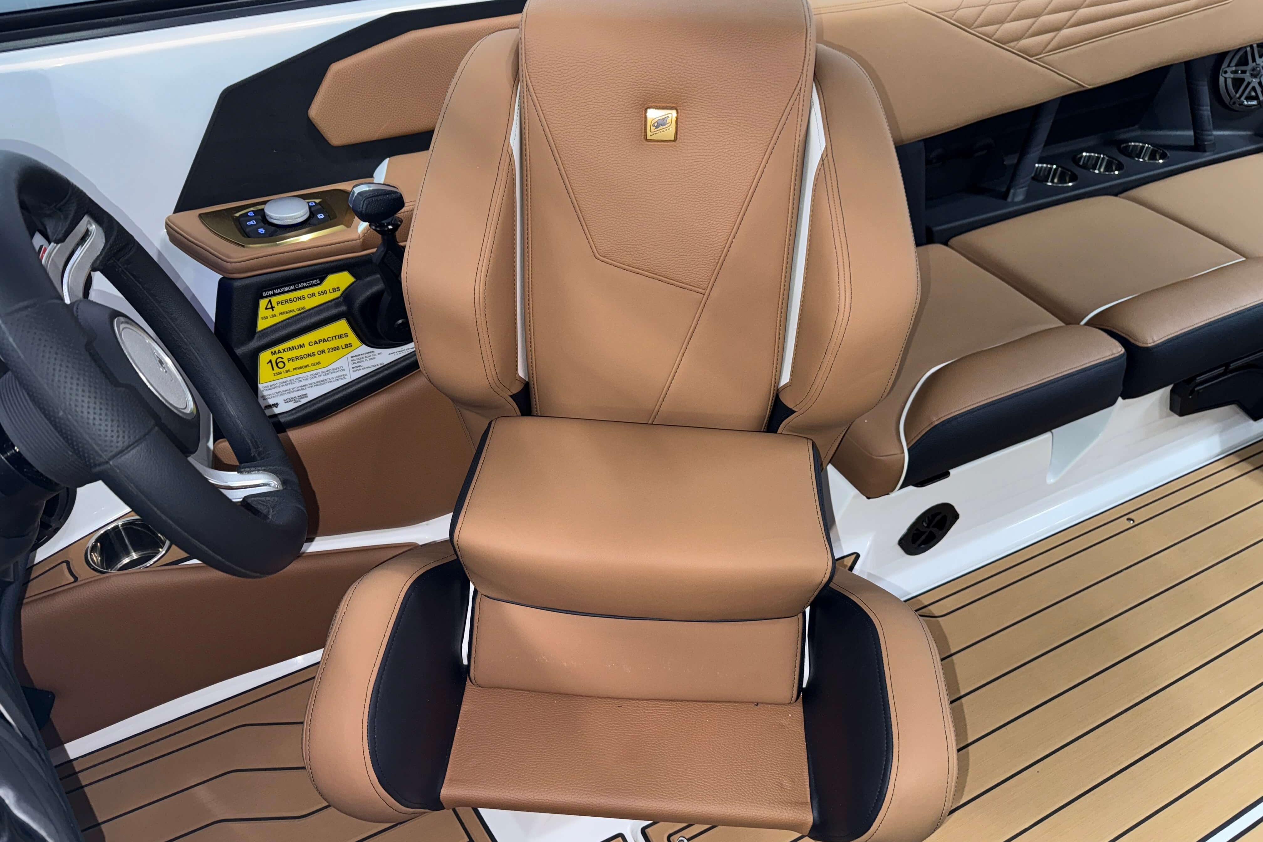 2026 Nautique Super Air Nautique S23 interior with tan leather seating and modern controls.