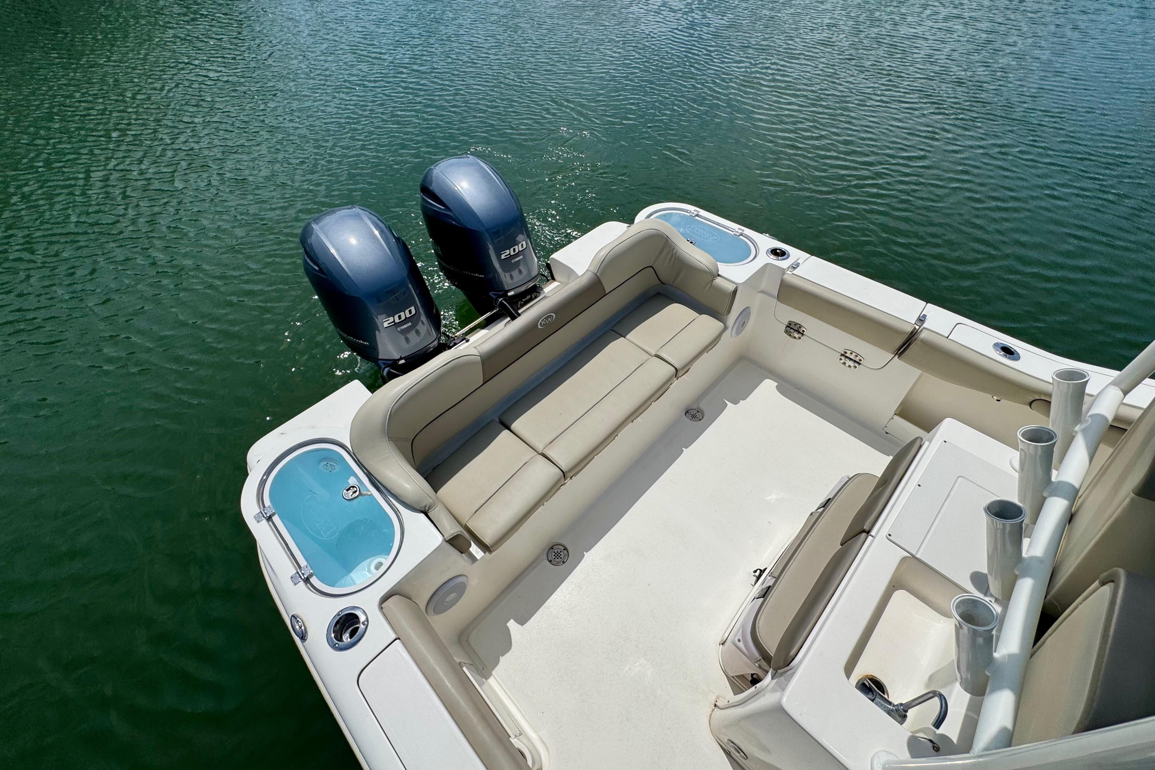 2022 Key West 263 FS boat with dual engines and spacious seating on water.