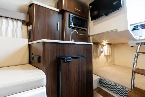 2016 Regal 28 Express cabin interior with kitchenette, bed, and TV.