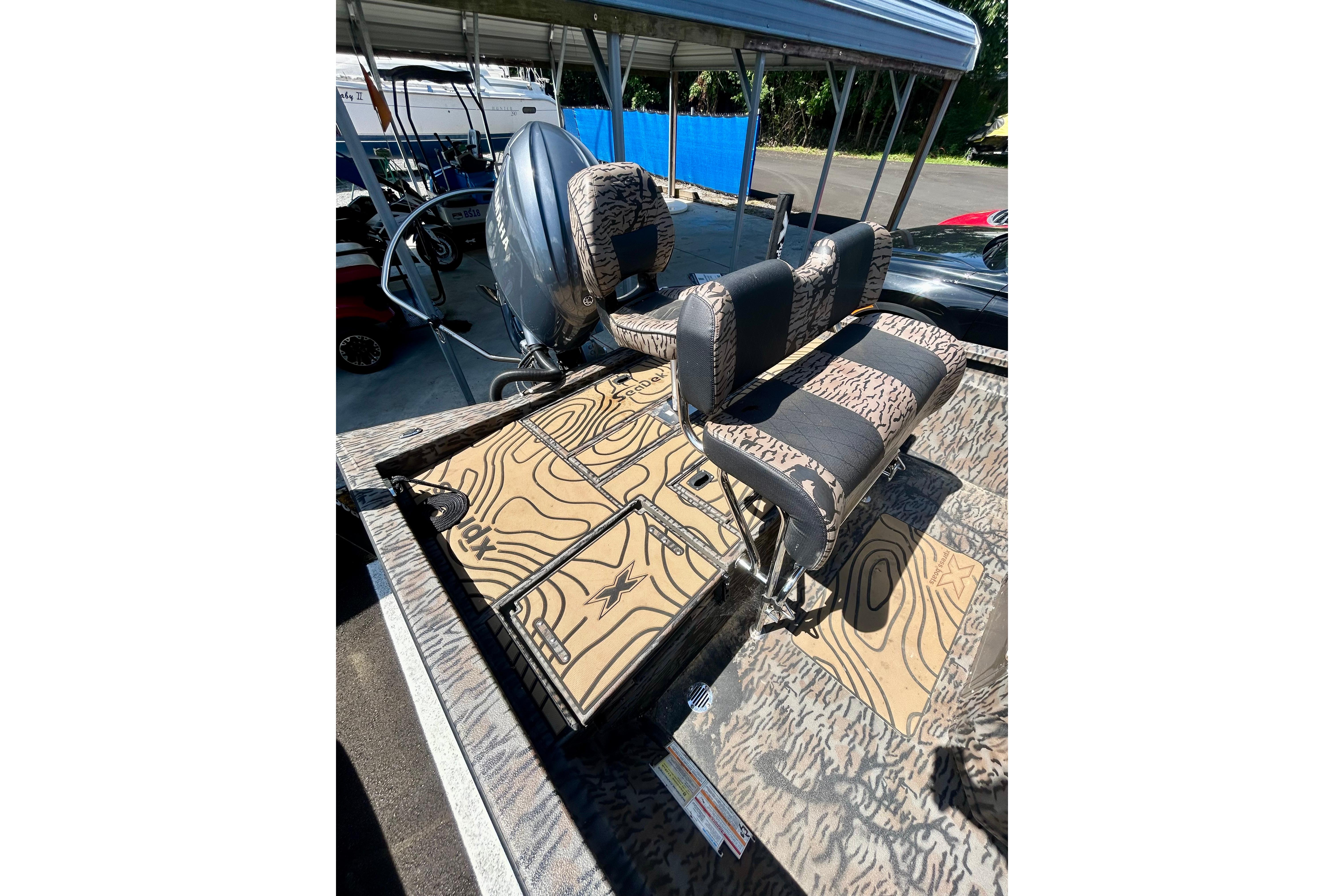 2025 Xpress H22B Bay boat interior with patterned seating and deck design.