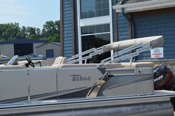 2018 Tahoe LTZ 2285 CR pontoon boat docked near a building.