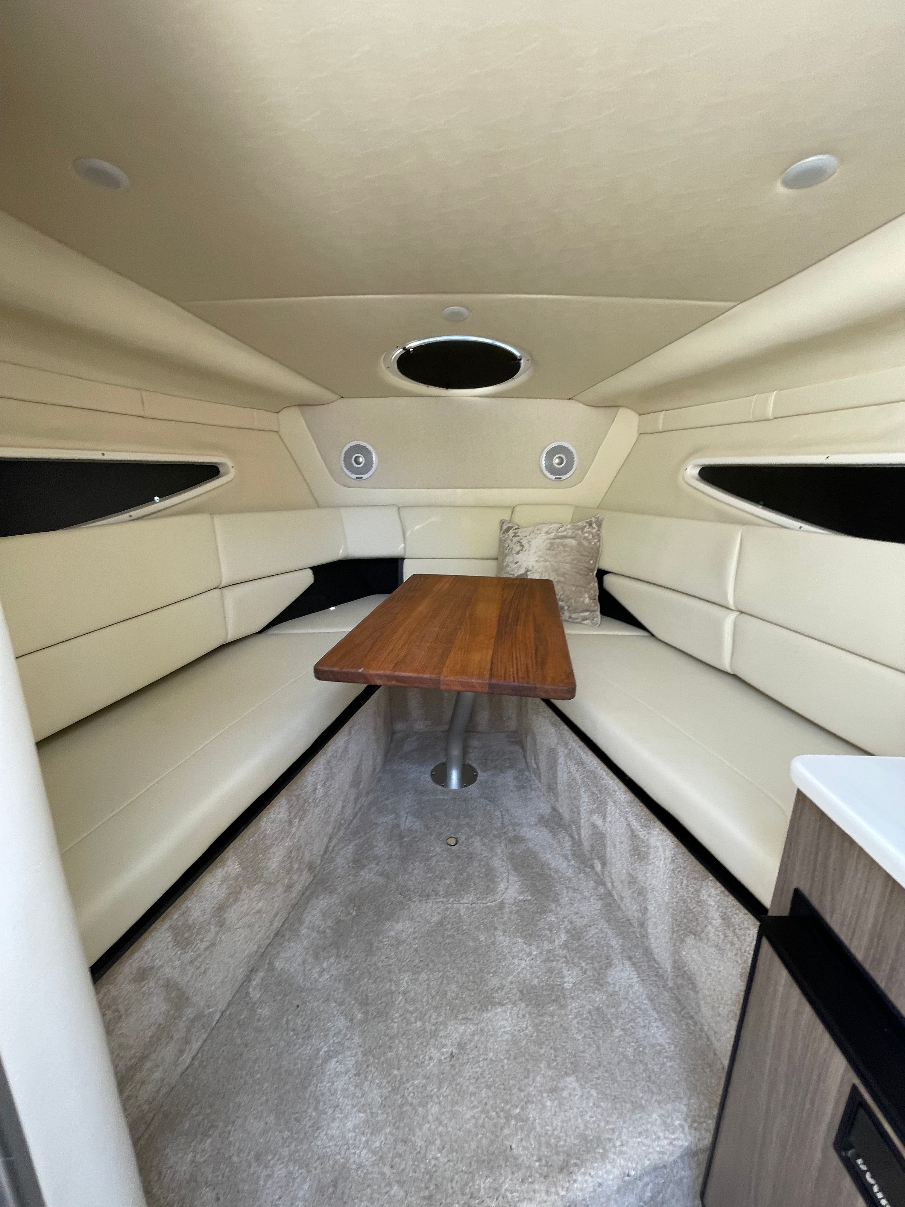 Interior of 2022 Regal 26 Express with table and seating area.