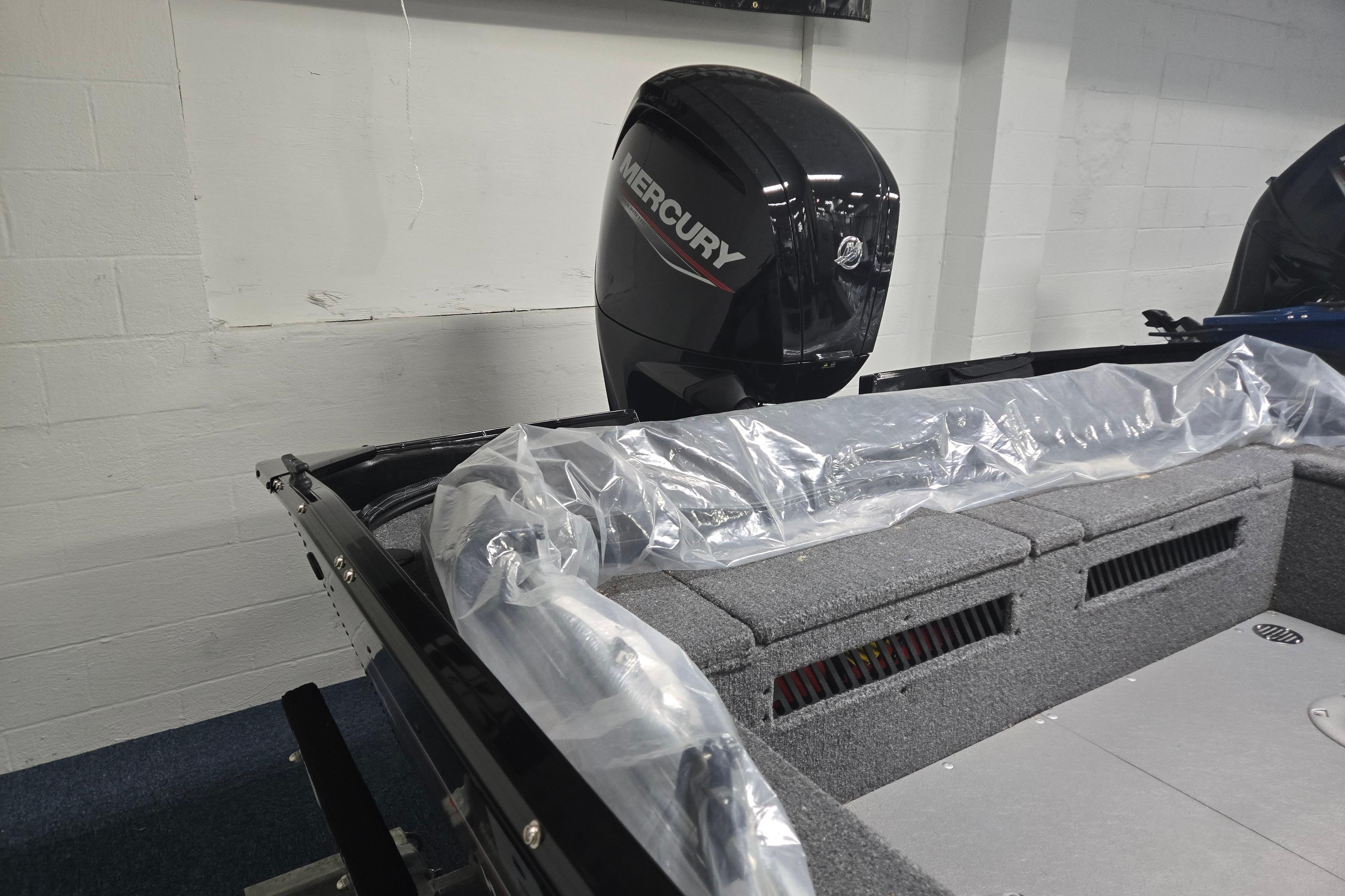2026 Princecraft Holiday 162 WS MAX boat with Mercury outboard motor in showroom.