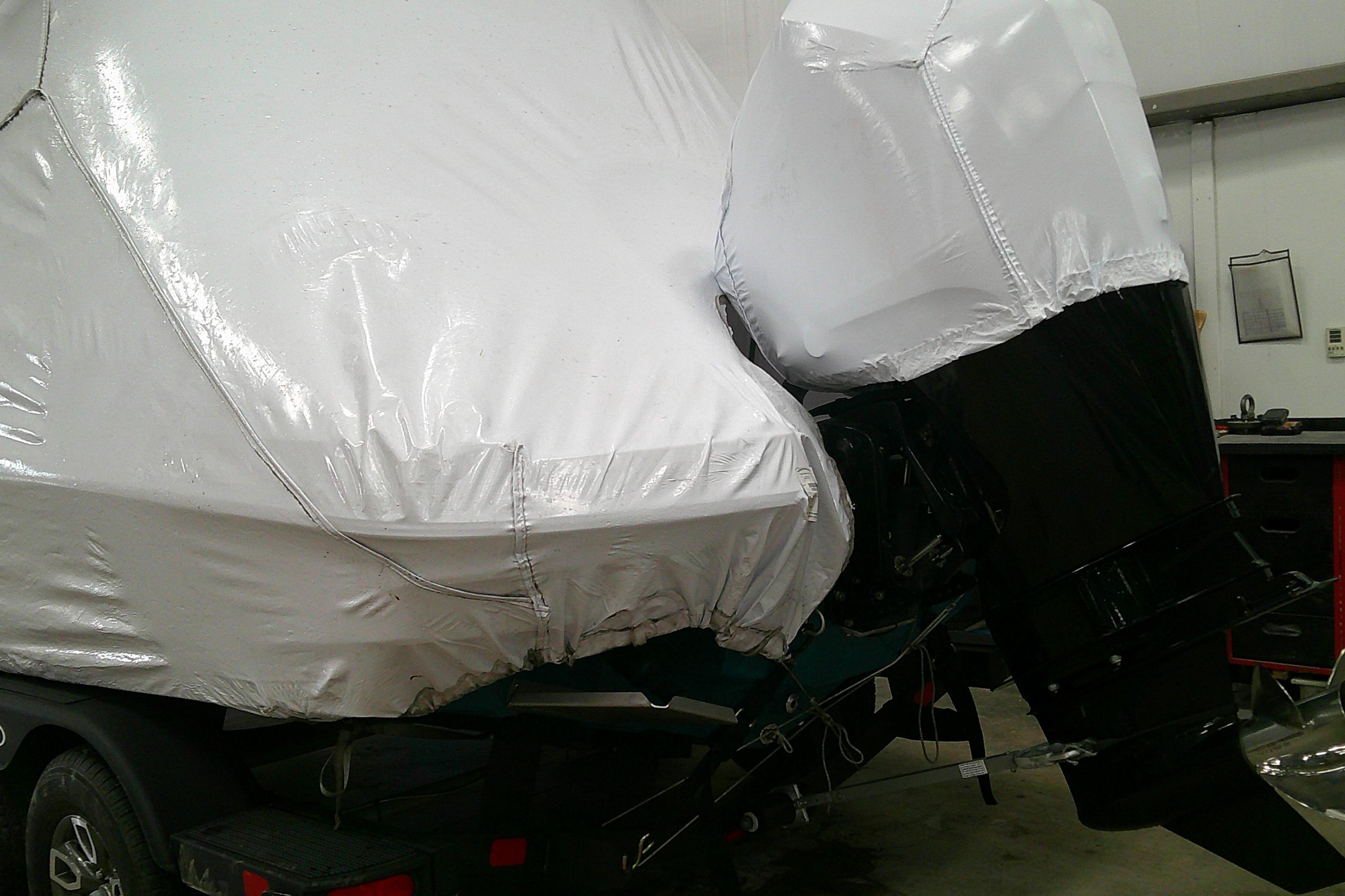 2026 Tahoe 2150 CC boat covered in protective wrap, stored indoors.