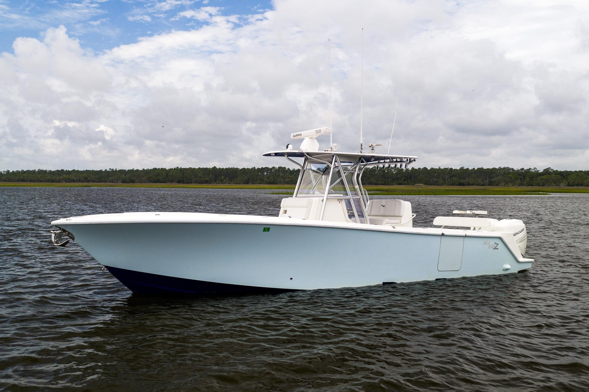 2019 SeaVee 322Z boat on calm water under cloudy sky.