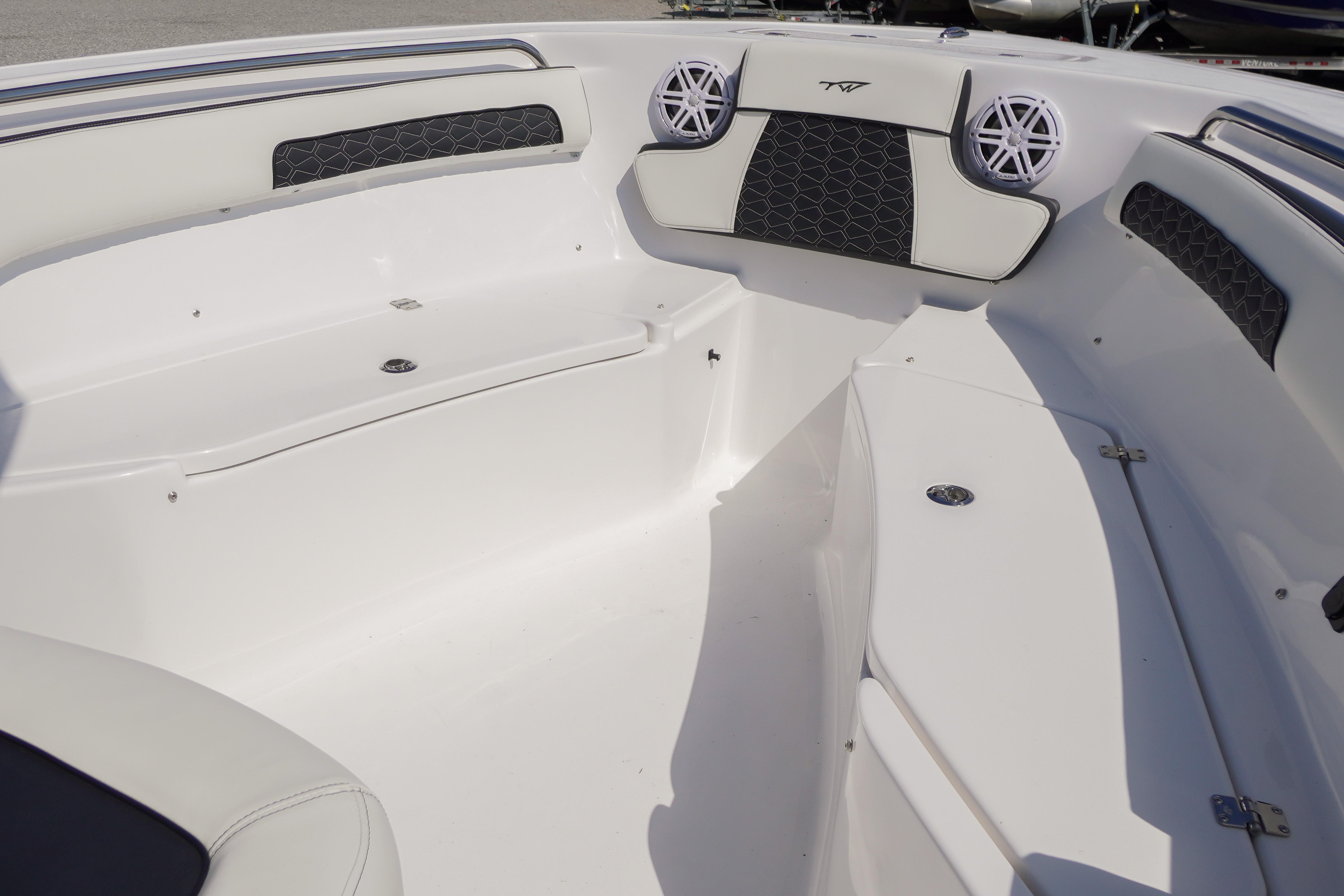 2026 Tidewater 220 CC Adventure boat interior with cushioned seating and speakers.