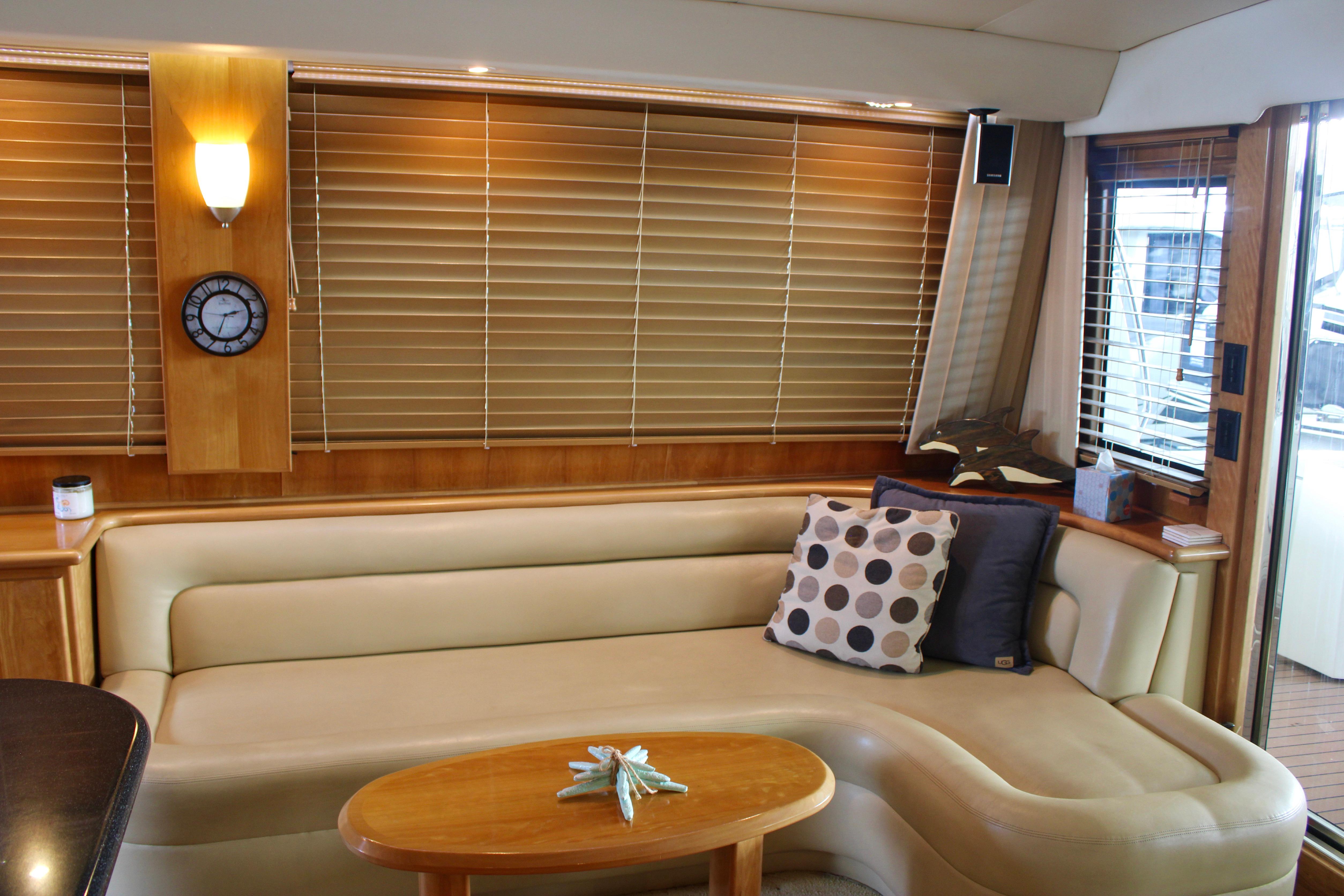 Luxurious 2007 Navigator 5100 yacht interior with beige leather seating and wooden accents.
