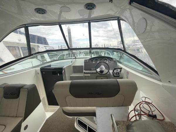 2014 Sea Ray 310 Sundancer cockpit with steering wheel and dashboard.