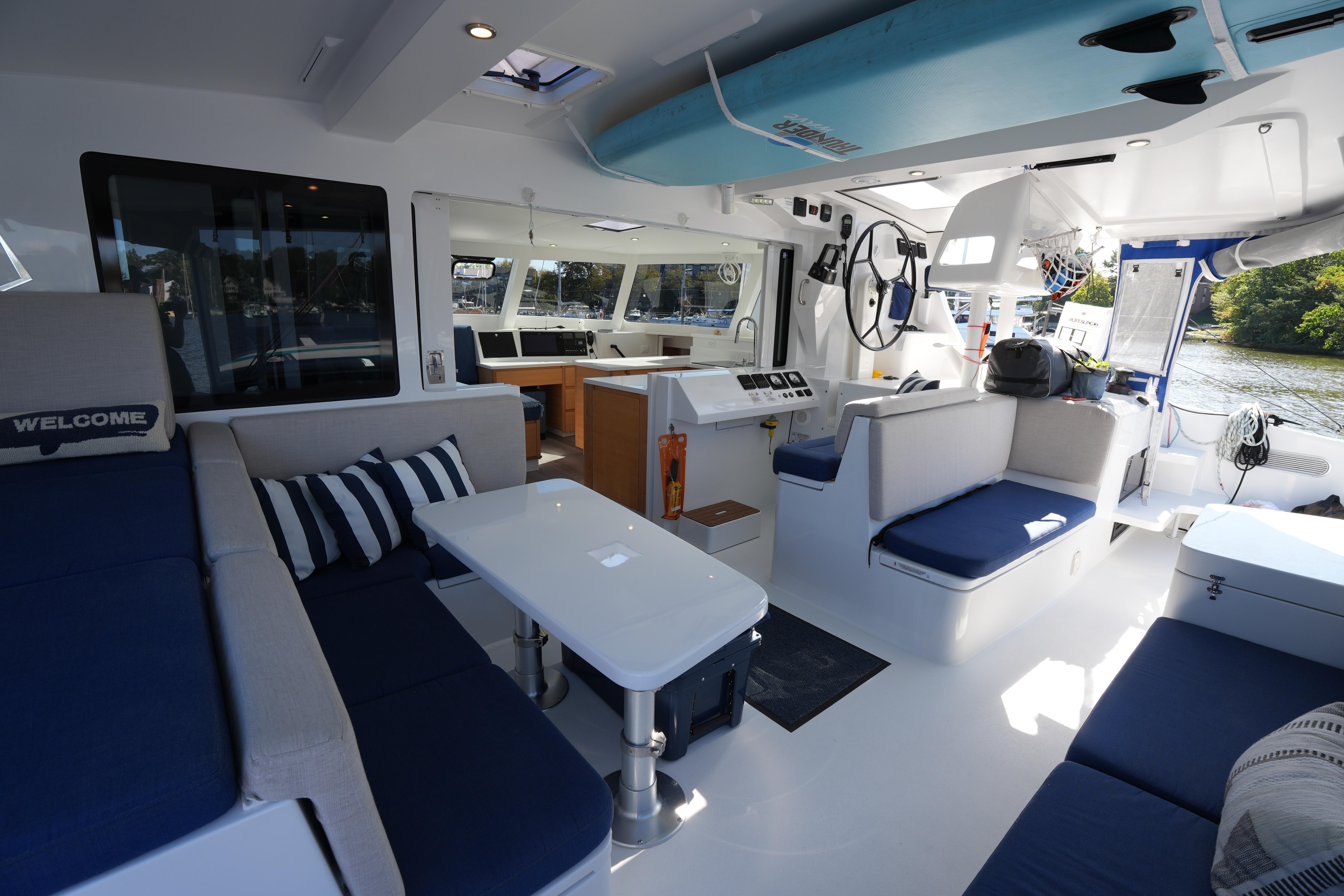 Luxurious interior of 2024 Balance 442 catamaran with modern seating and navigation area.