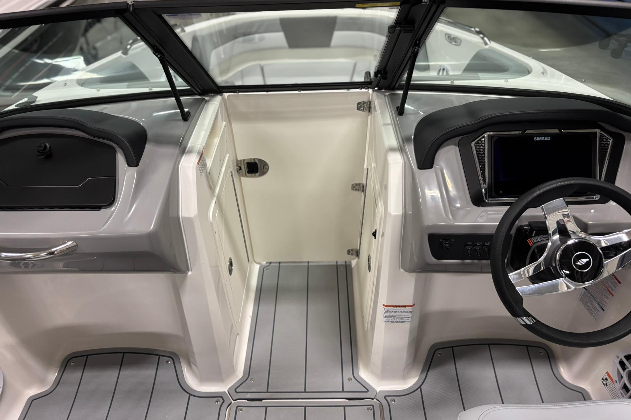 2026 Chaparral 21 SSi OB boat interior with steering wheel and dashboard controls.