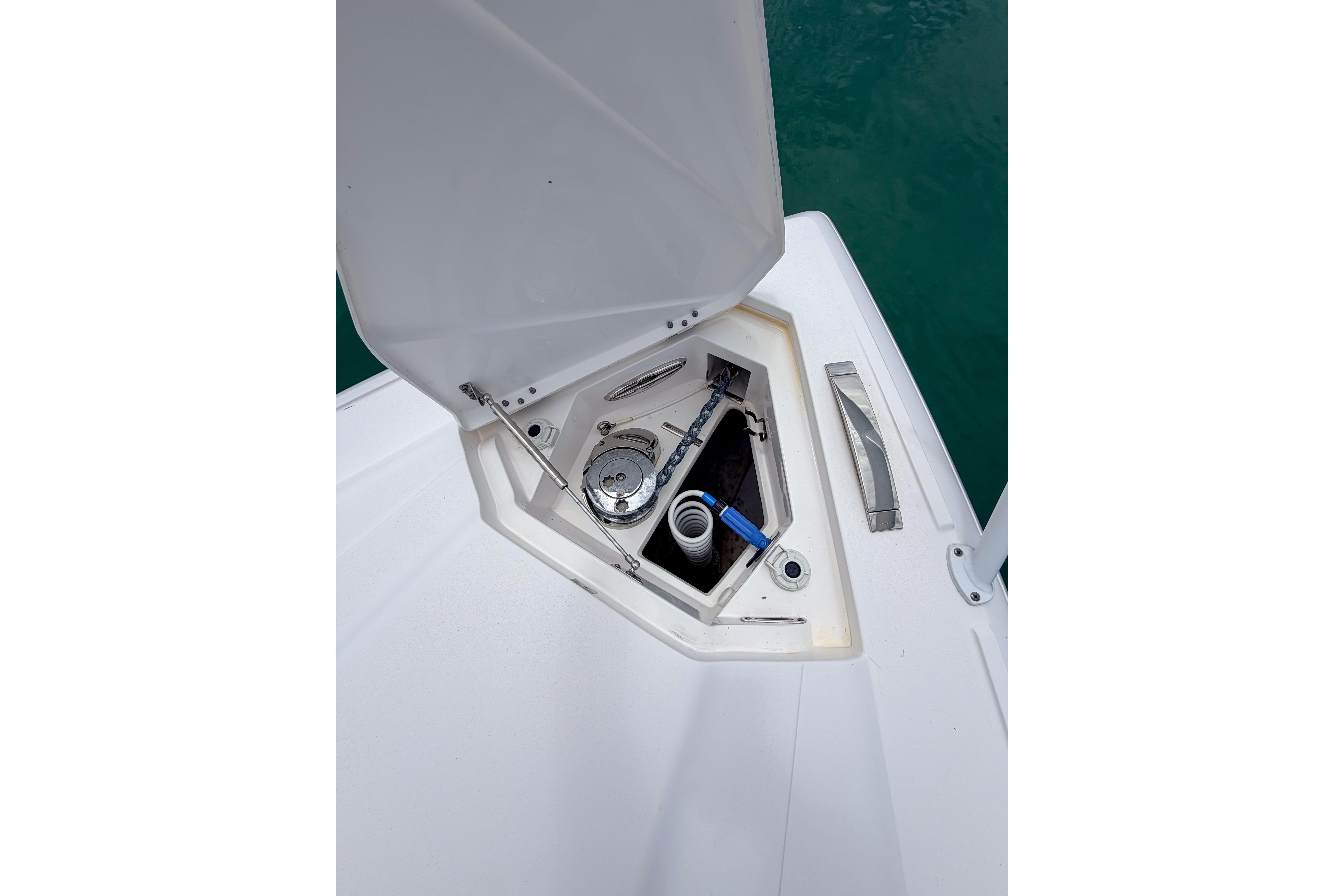 Open anchor locker on 2021 Intrepid 409 Valor boat, showing anchor and rope storage.