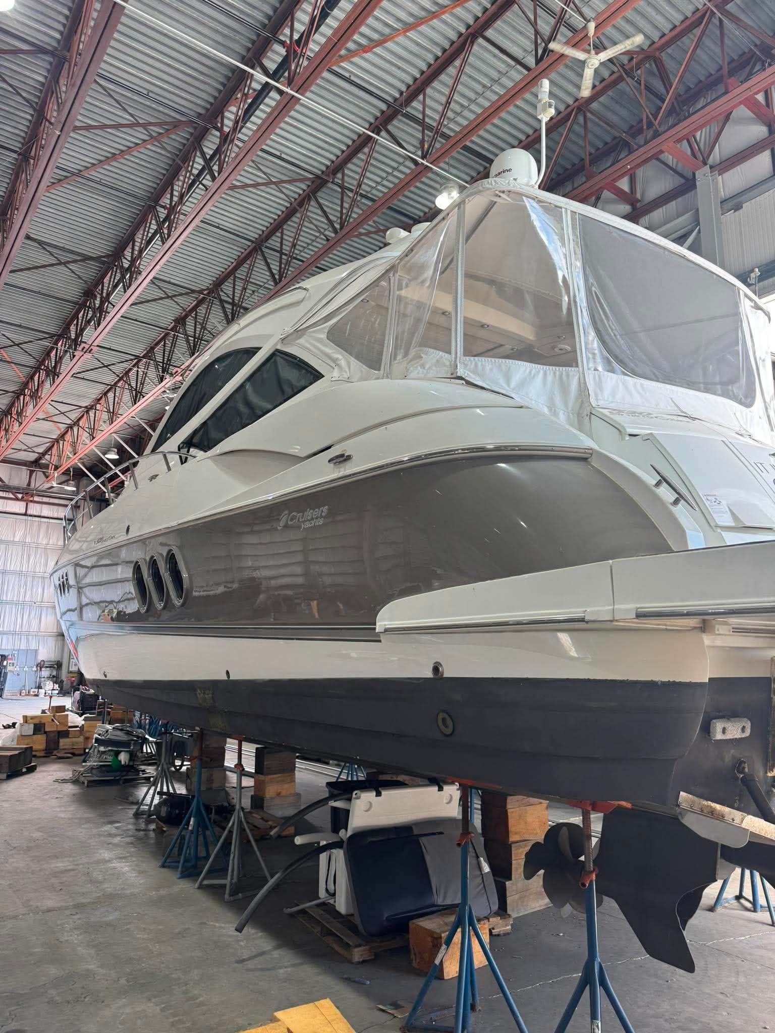 A 2009 Cruisers Yachts 520 Sports Coupe is in a shipyard warehouse.