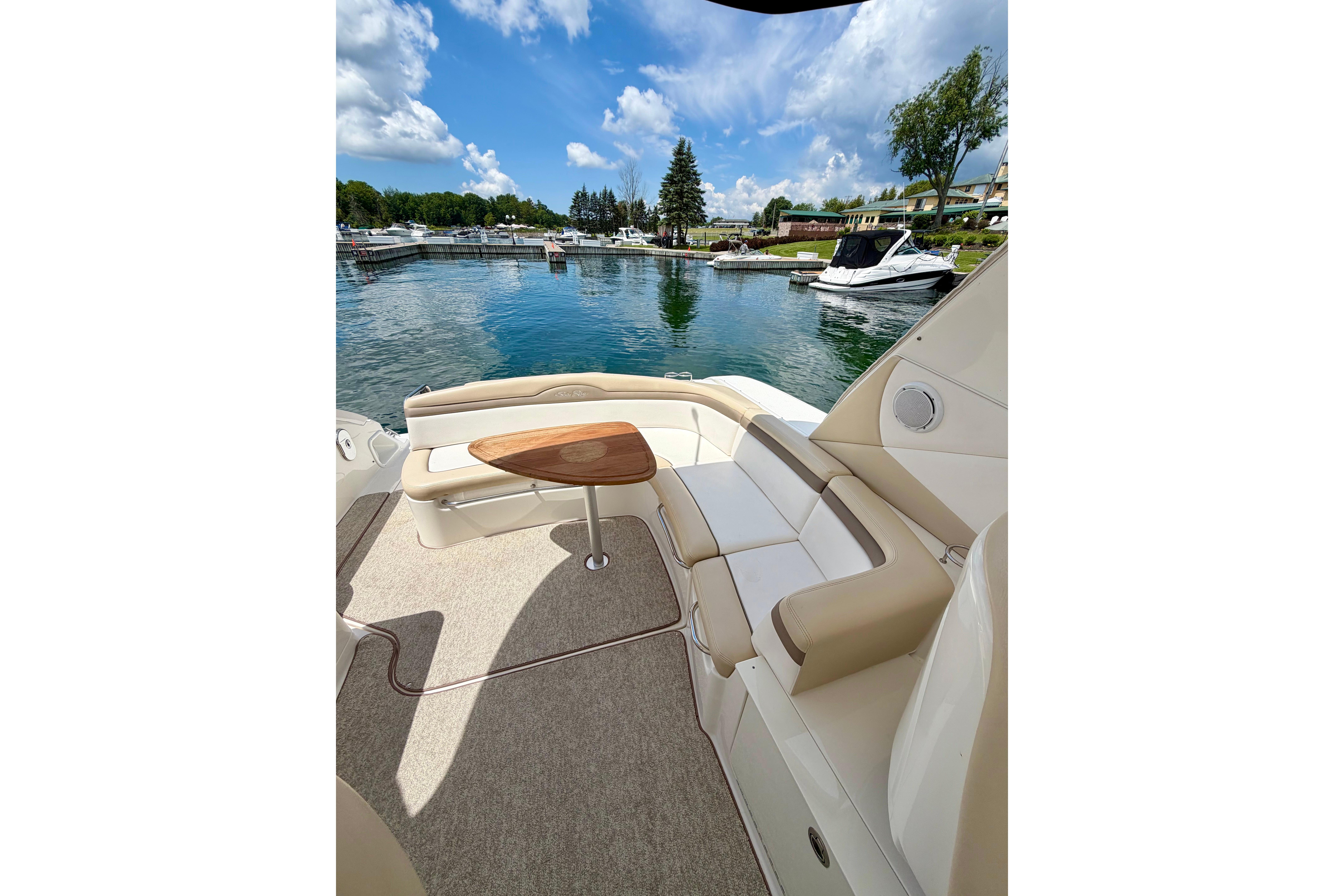 Luxurious 2012 Sea Ray Sundancer 370 yacht interior with elegant seating and scenic marina view.