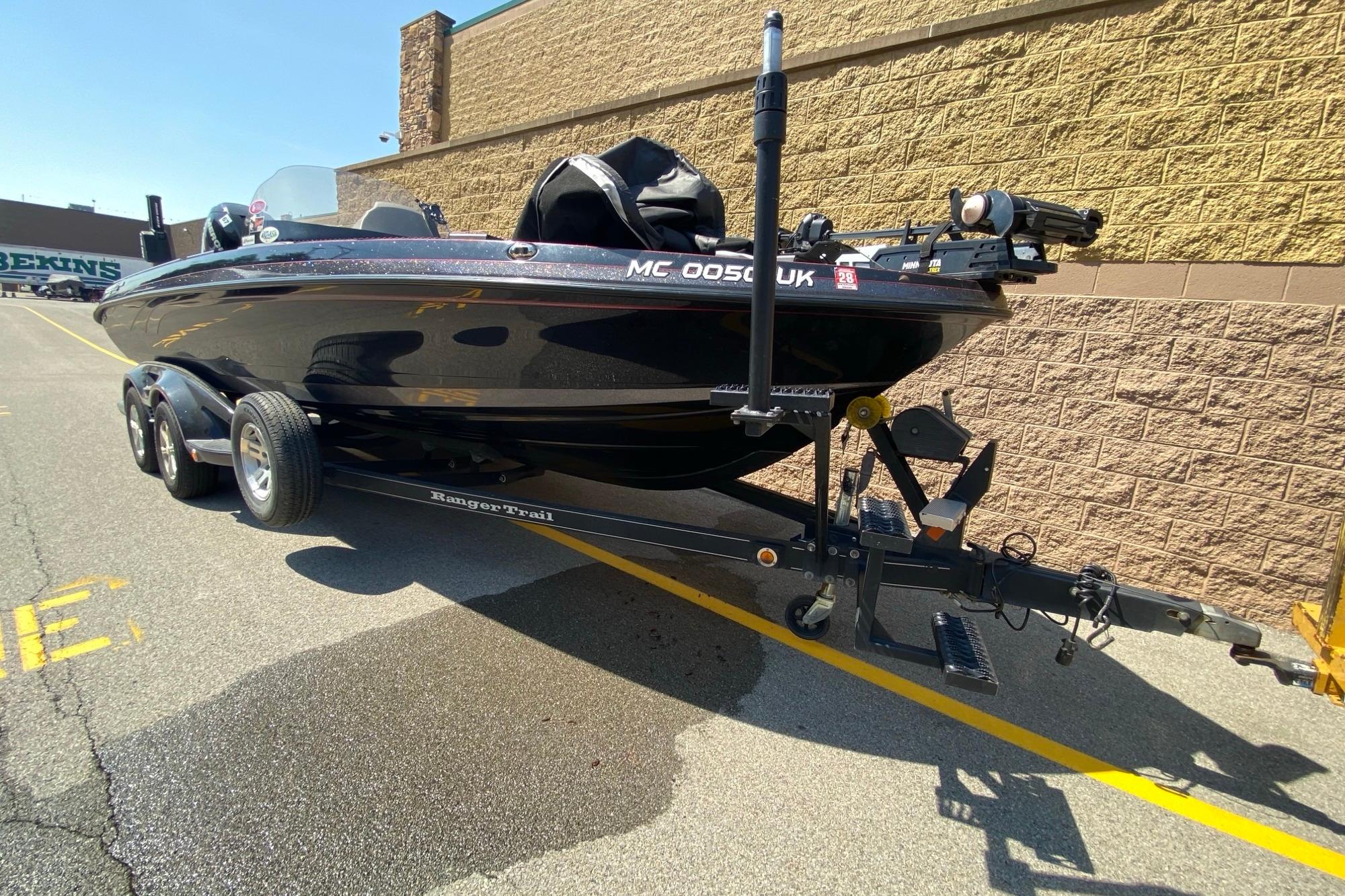 2017 Ranger 621FS Fisherman boat on trailer, parked beside a brick wall.