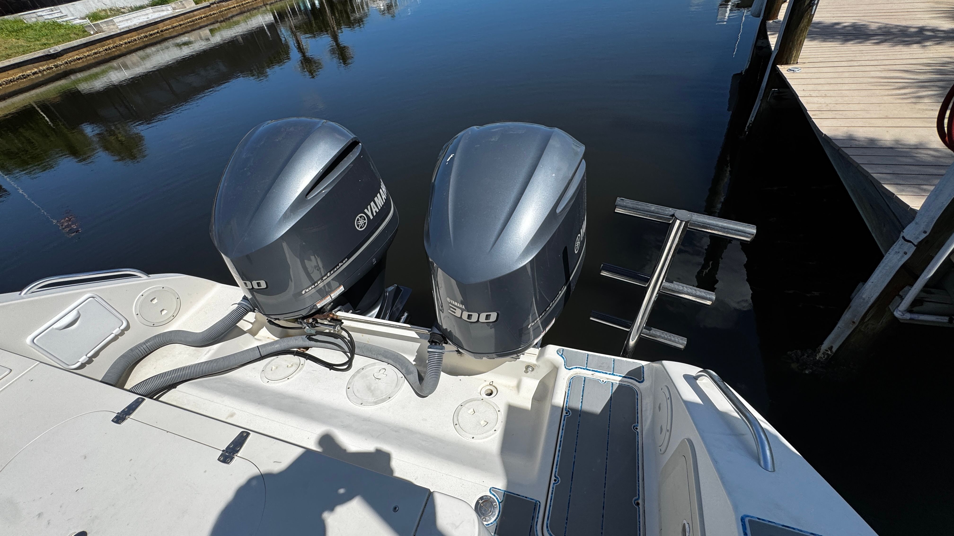Two Yamaha outboard motors at a boat dock.