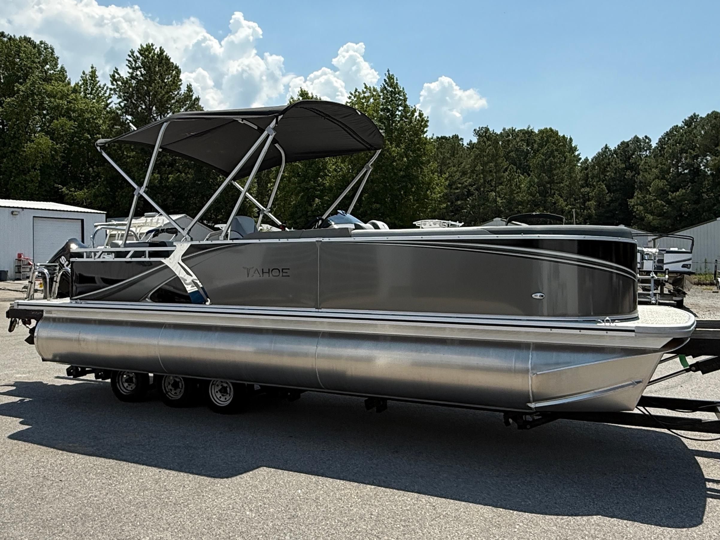 2025 Tahoe Pontoon LTZ Cruise boat with canopy, parked outdoors on a sunny day.