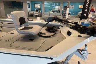 2026 Crestliner 1860 Retriever CC boat interior with seating and controls in showroom.