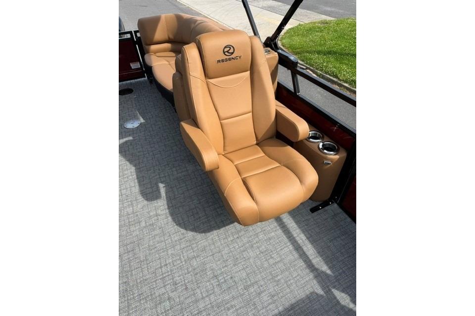 Luxurious tan seating on 2026 Regency 230 DL boat, featuring cup holders and plush design.