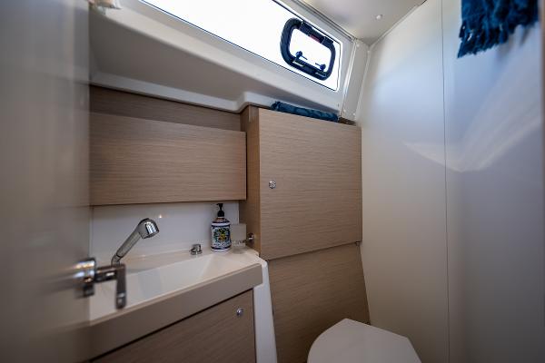 Interior of Beneteau Oceanis 38.1, 2021, bathroom with sink and toilet.