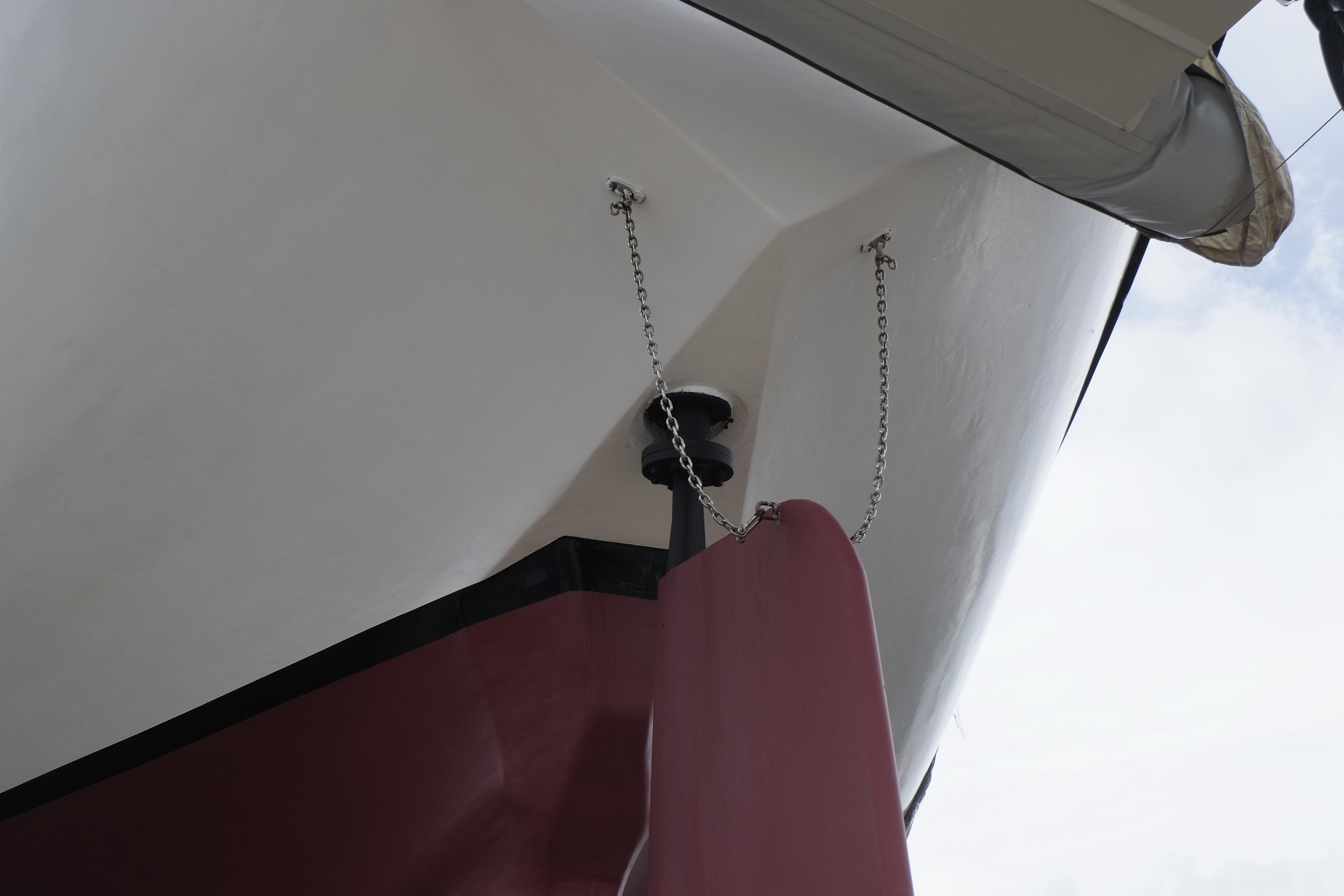 Close-up of a 2006 Custom Bud Macintosh schooner's bow with chains and red detailing.
