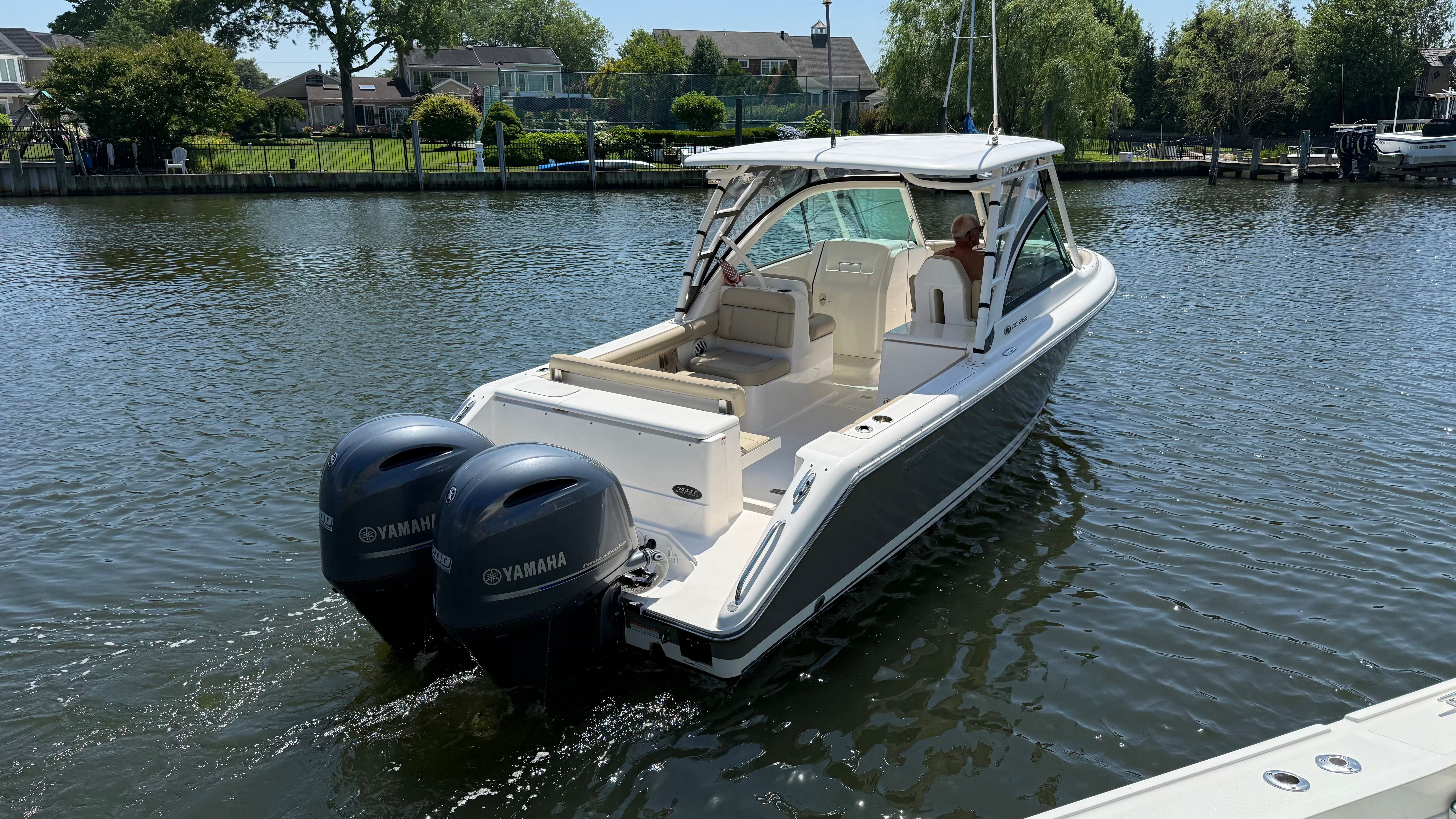 A 2016 Pursuit DC 265 Dual Console boat on calm water.