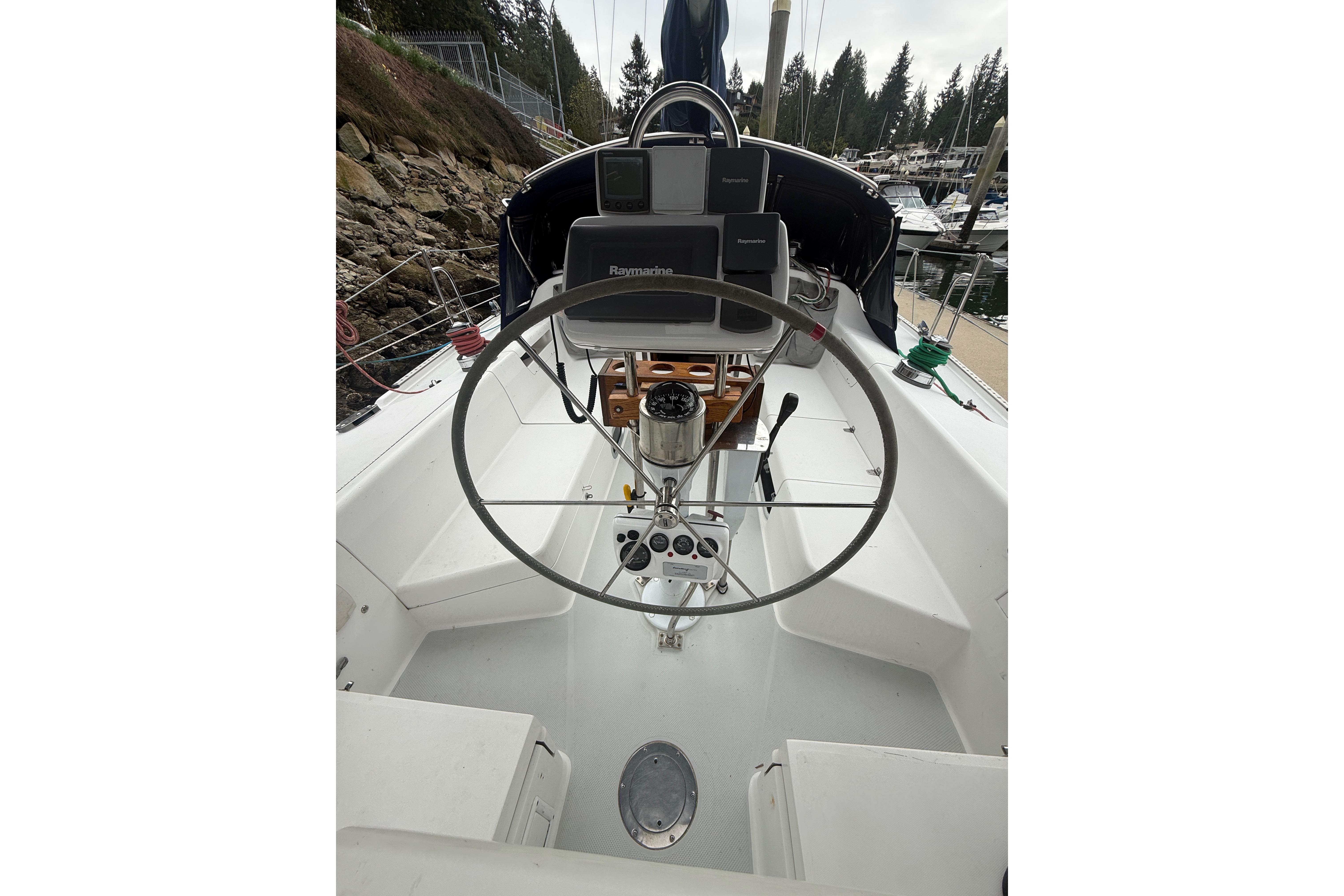 Cockpit of 2003 Catalina 34 MkII sailboat with steering wheel and navigation equipment.