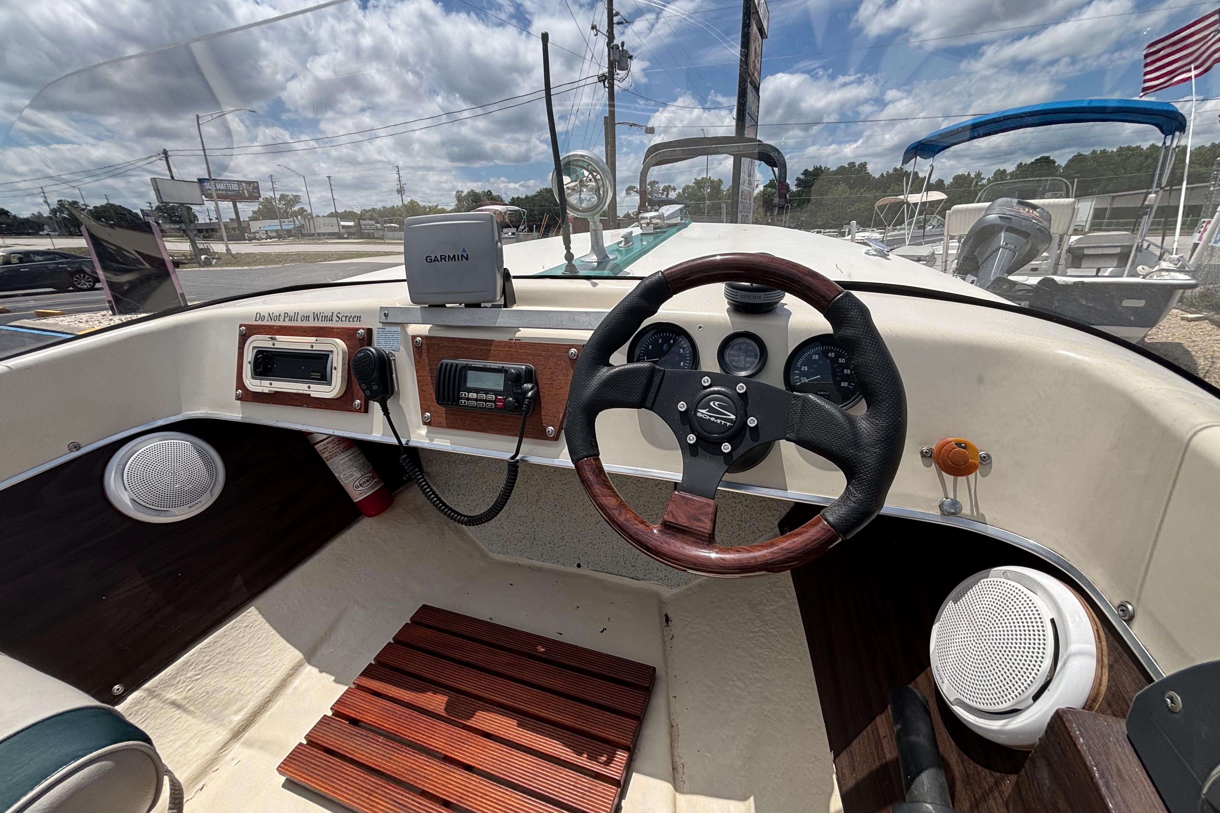 1966 Mohawk 15 boat dashboard with steering wheel, gauges, and Garmin device.