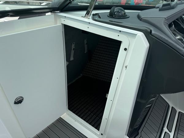 Open storage compartment on 2018 Monterey 258 Super Sport boat interior.