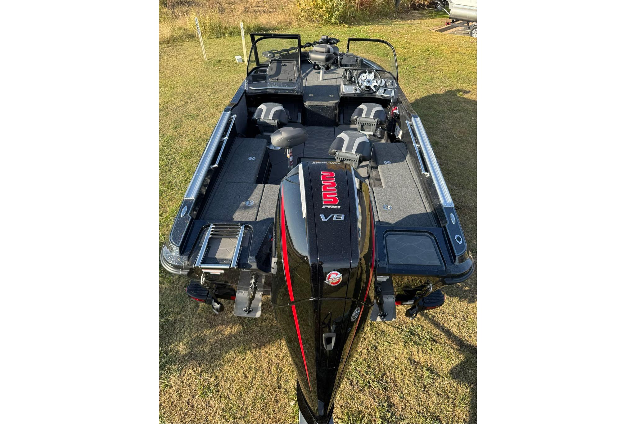 2026 Nitro ZV20 Pro boat with V8 engine, parked on grass.