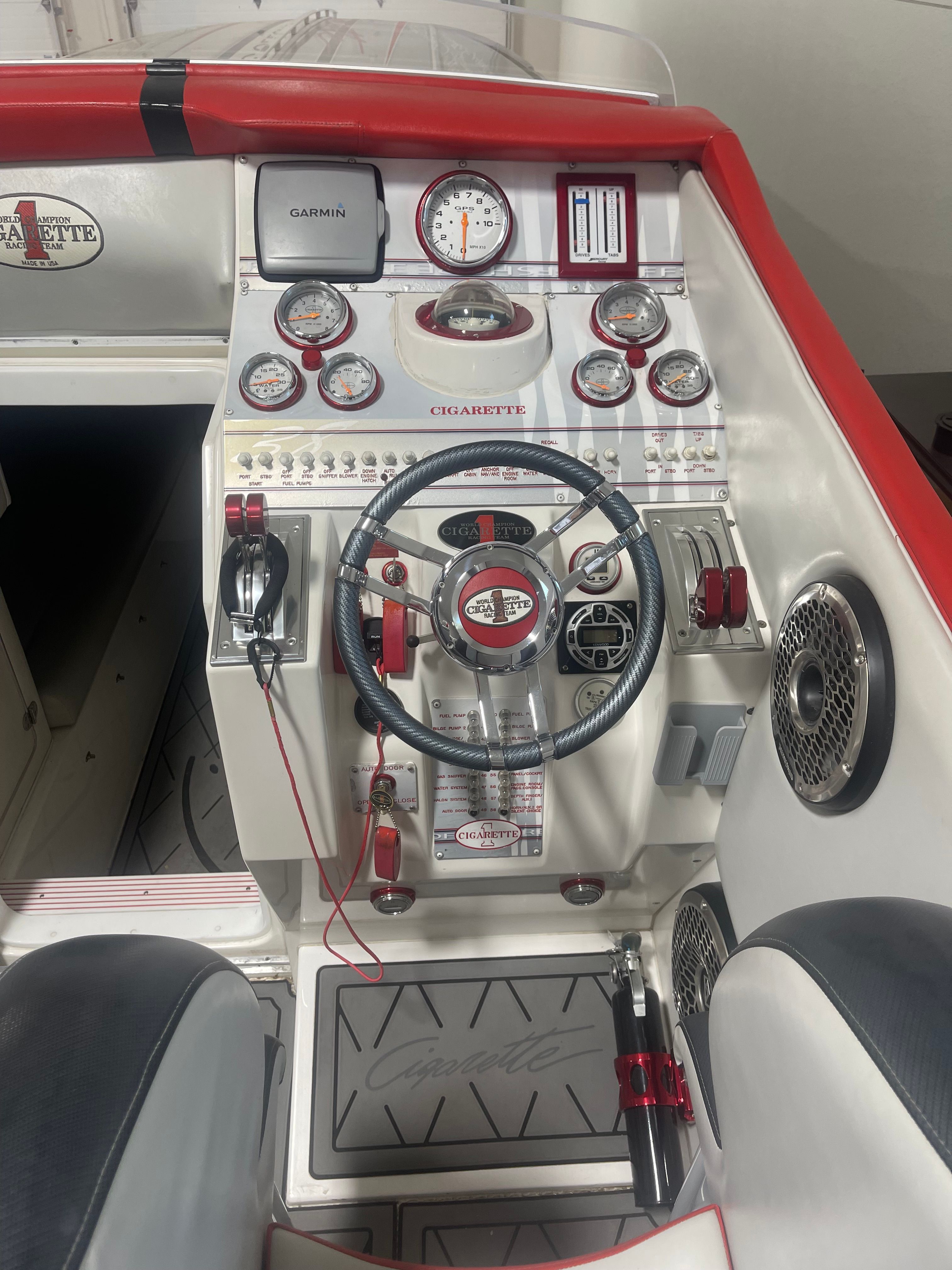 Cockpit of a 2004 Cigarette 38' Top Gun boat with steering and instruments.