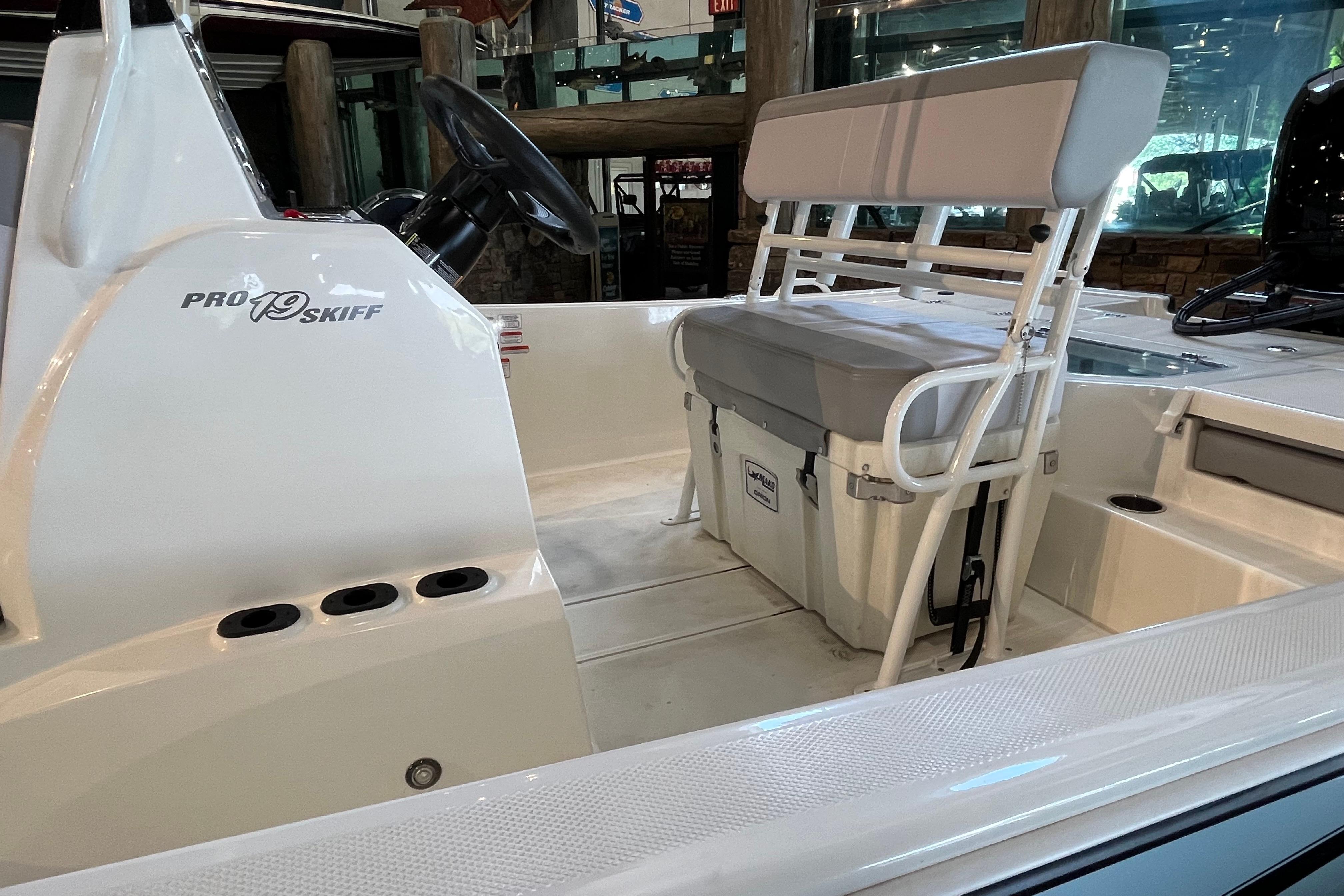 2024 Mako Pro Skiff 19 CC interior with seating and steering console.