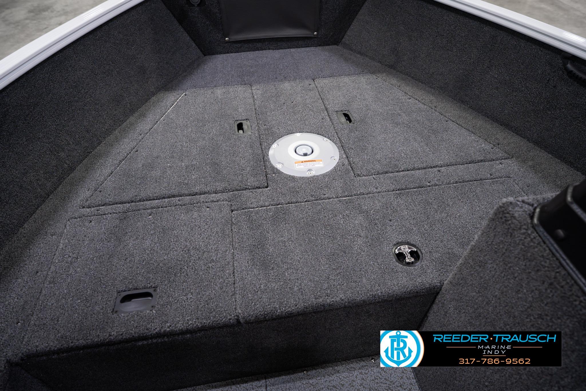 2026 Lund 1650 Rebel XL SS boat interior with carpeted deck and storage compartments.