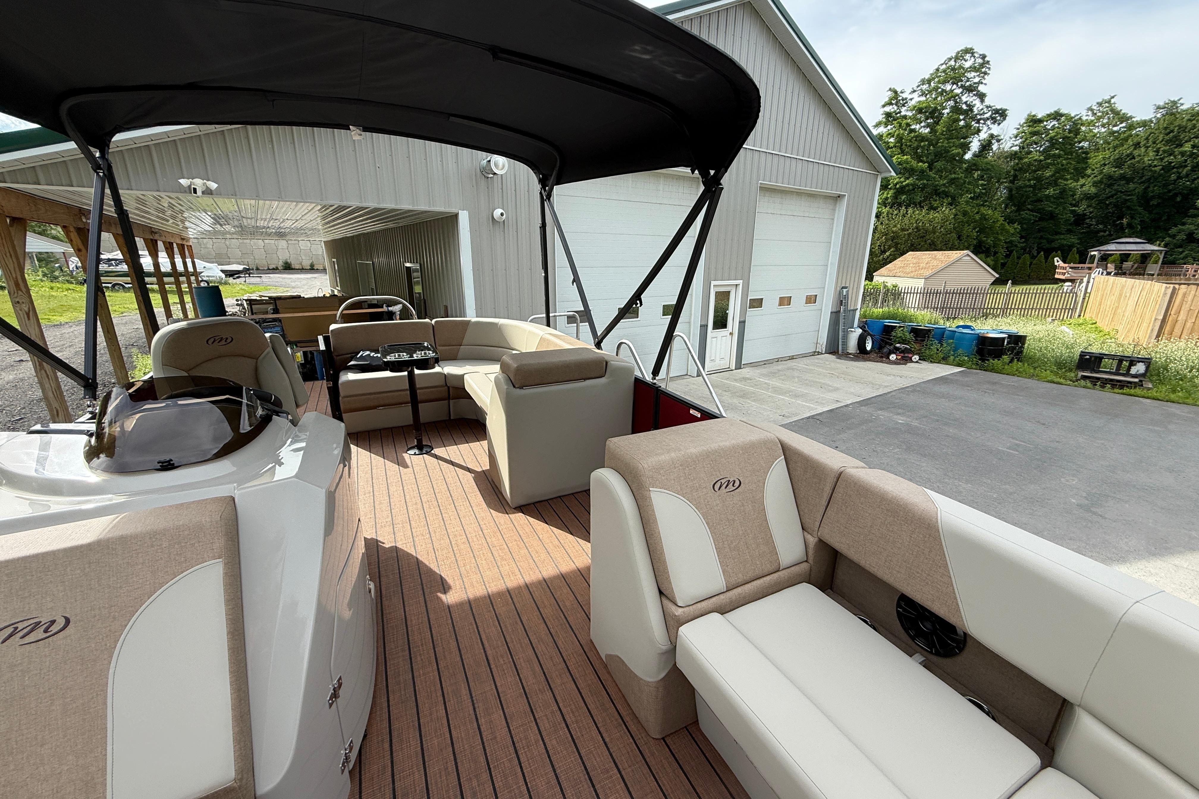 Interior view of 2027 Manitou 21 Aurora LE pontoon boat with beige seating.