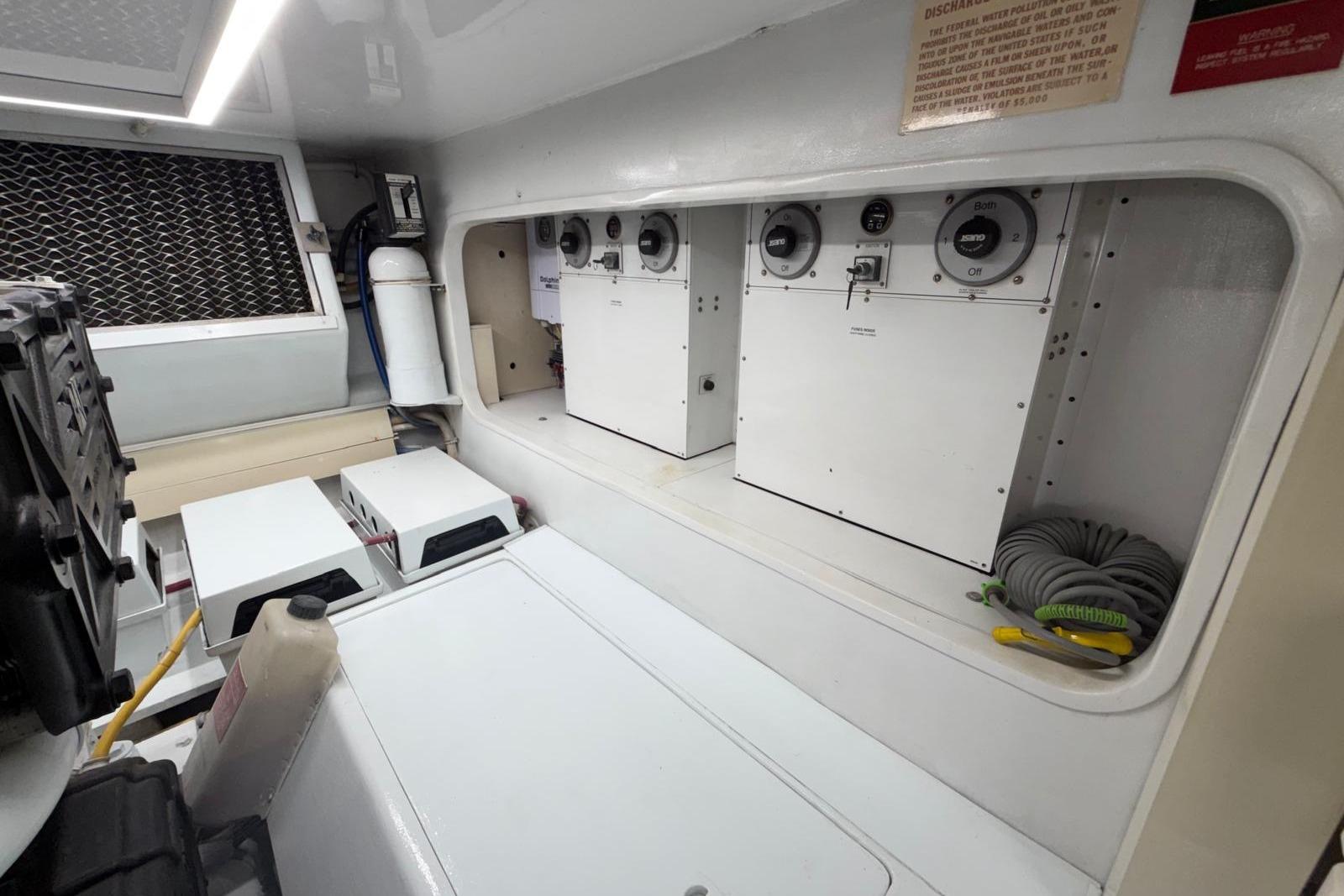 Engine room of a 2003 Hatteras 54 Convertible yacht, featuring control panels and equipment.