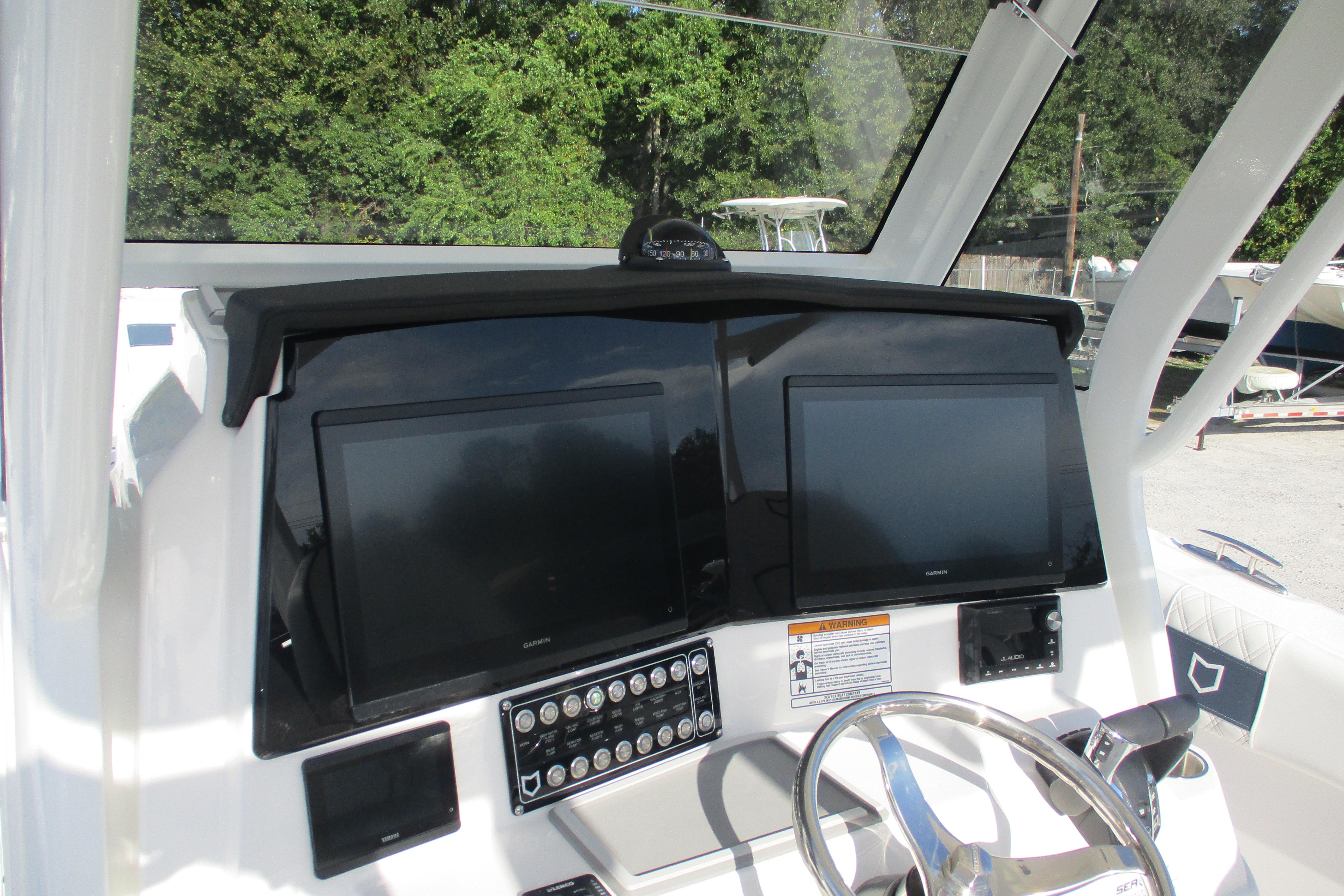 2026 Sea Fox 328 Commander dashboard with dual screens and steering wheel.