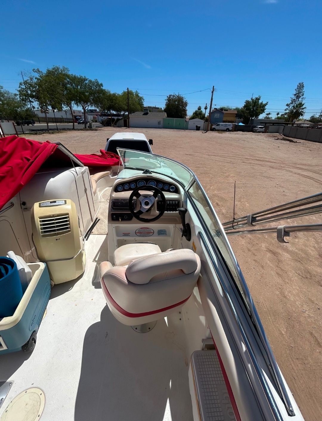 Interior view of a 2001 Chaparral Sunesta 233 boat with red cover.
