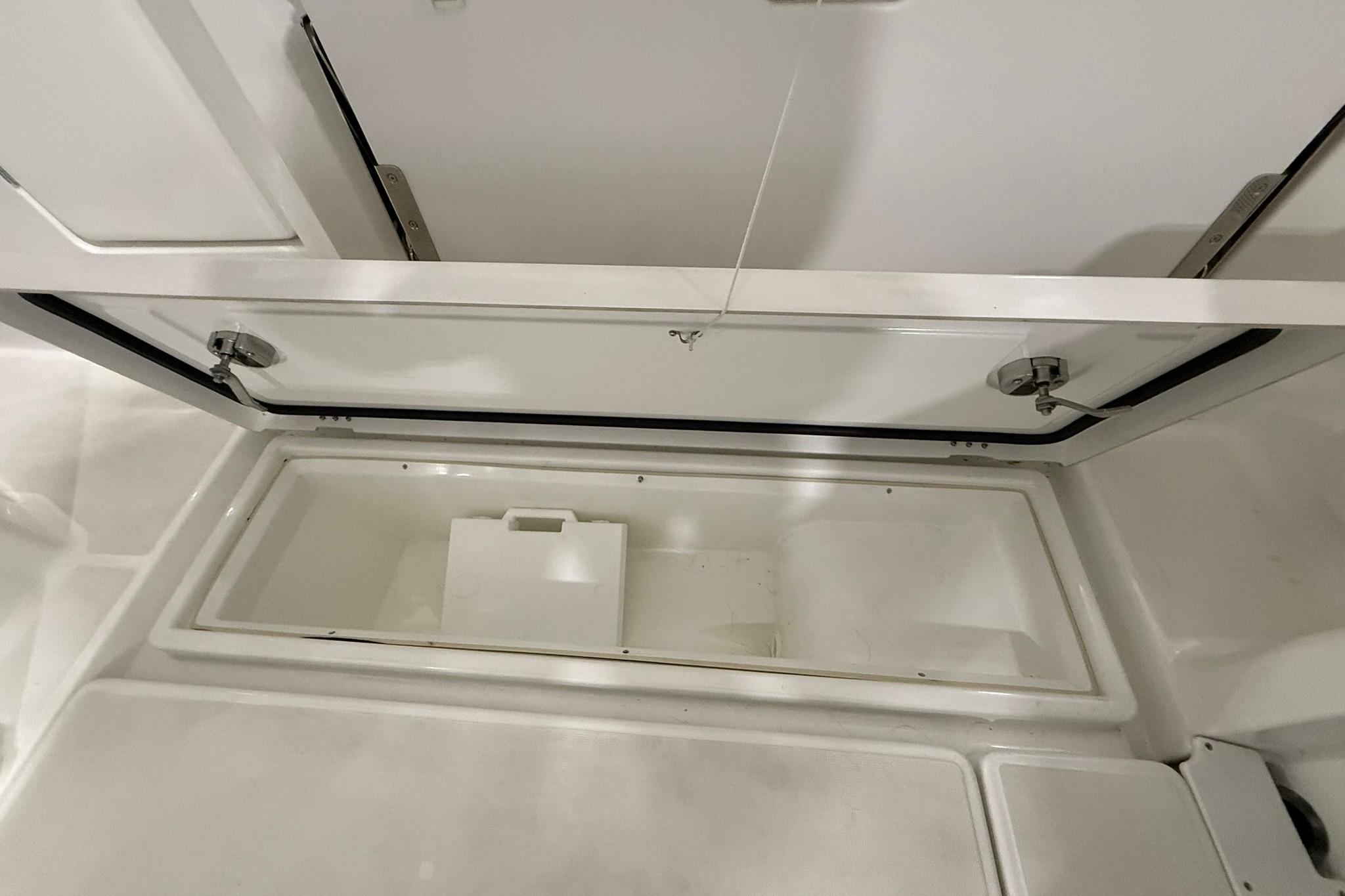 2024 Jeanneau NC Sport 795 Series 2 storage compartment, open and empty.