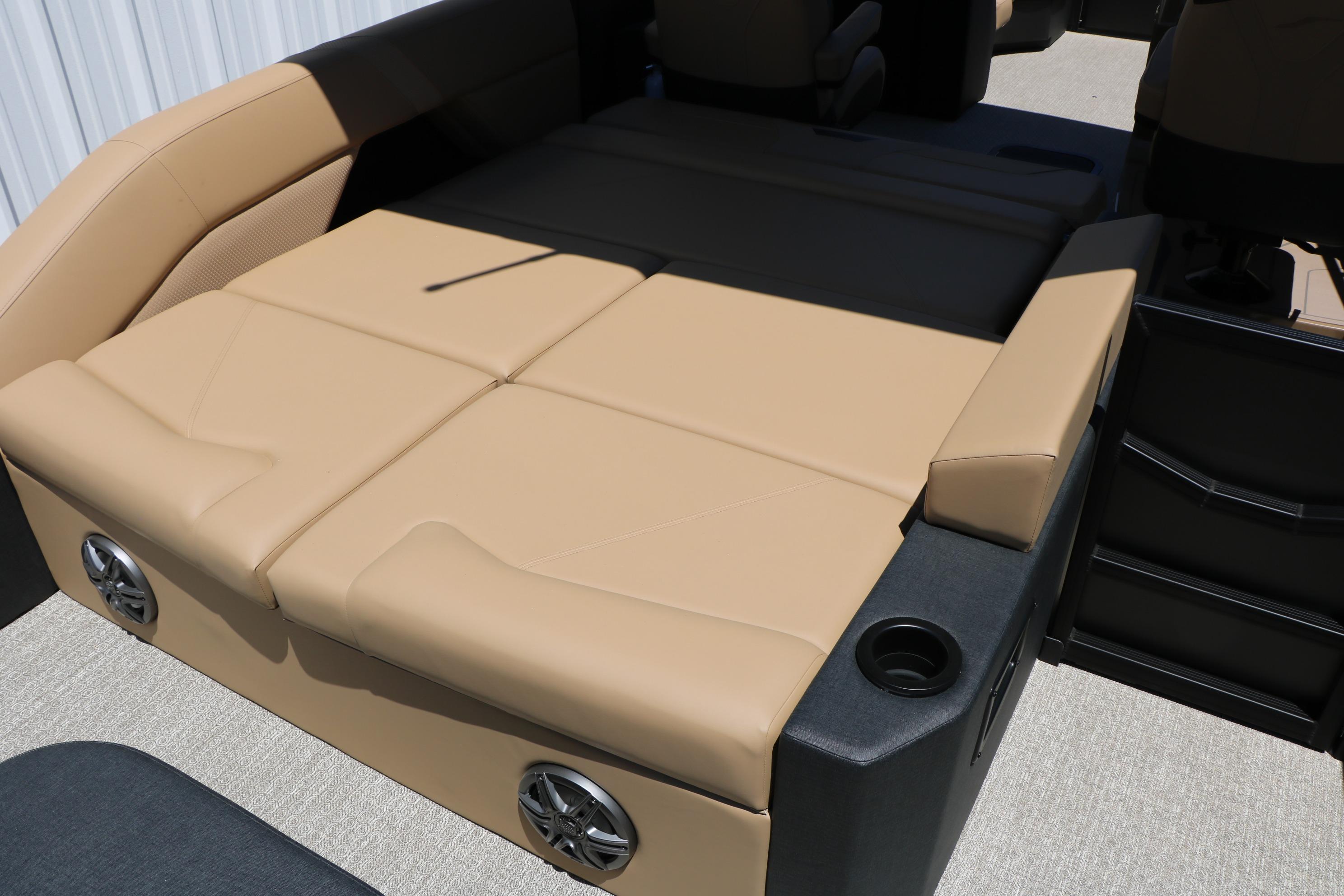 Luxurious seating area on the 2026 Evotti 521CS boat, featuring beige upholstery and built-in speakers.